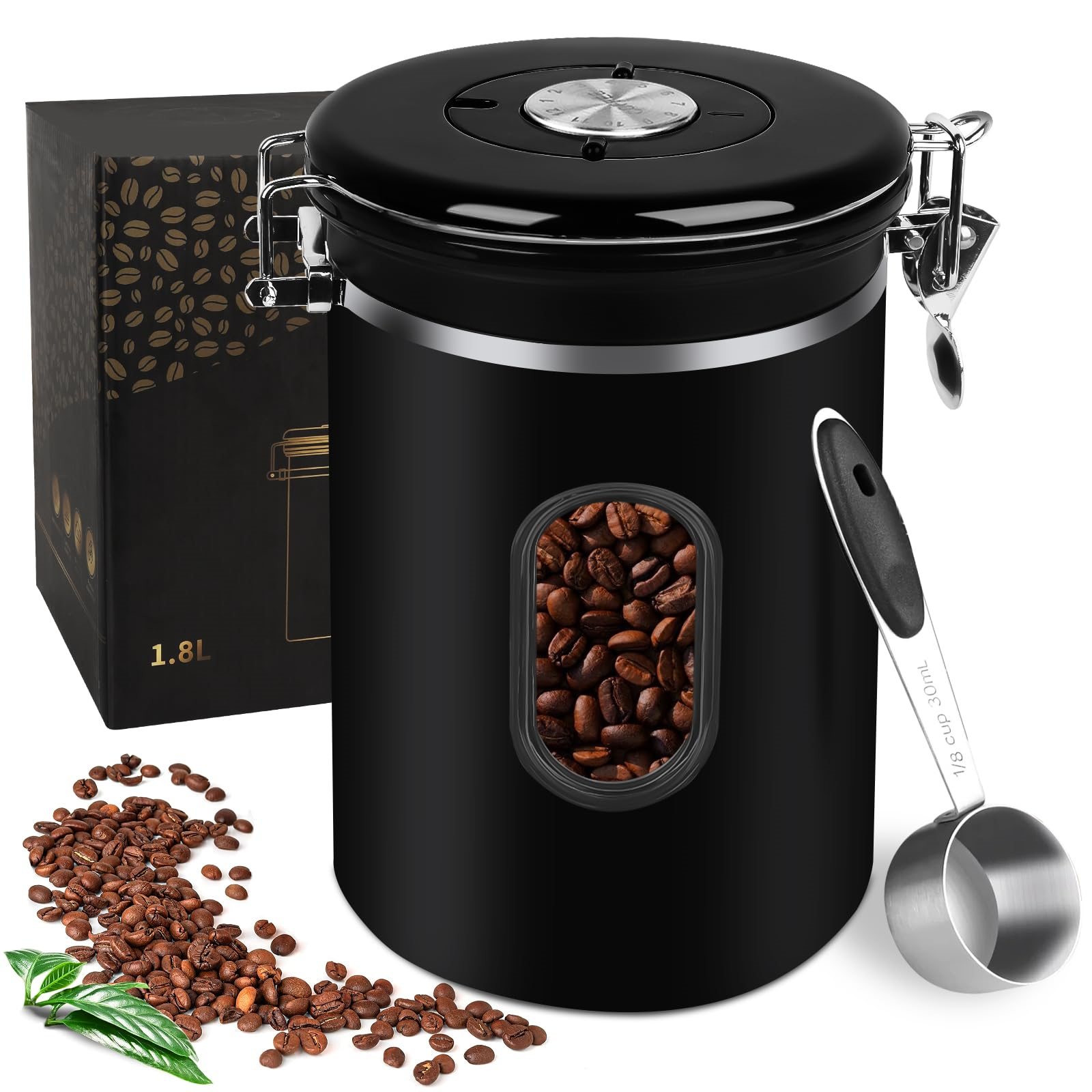Ein schwarzer Kaffeebehälter mit Bohnen durch ein Fenster, ein Löffel und eine Box werden gezeigt.