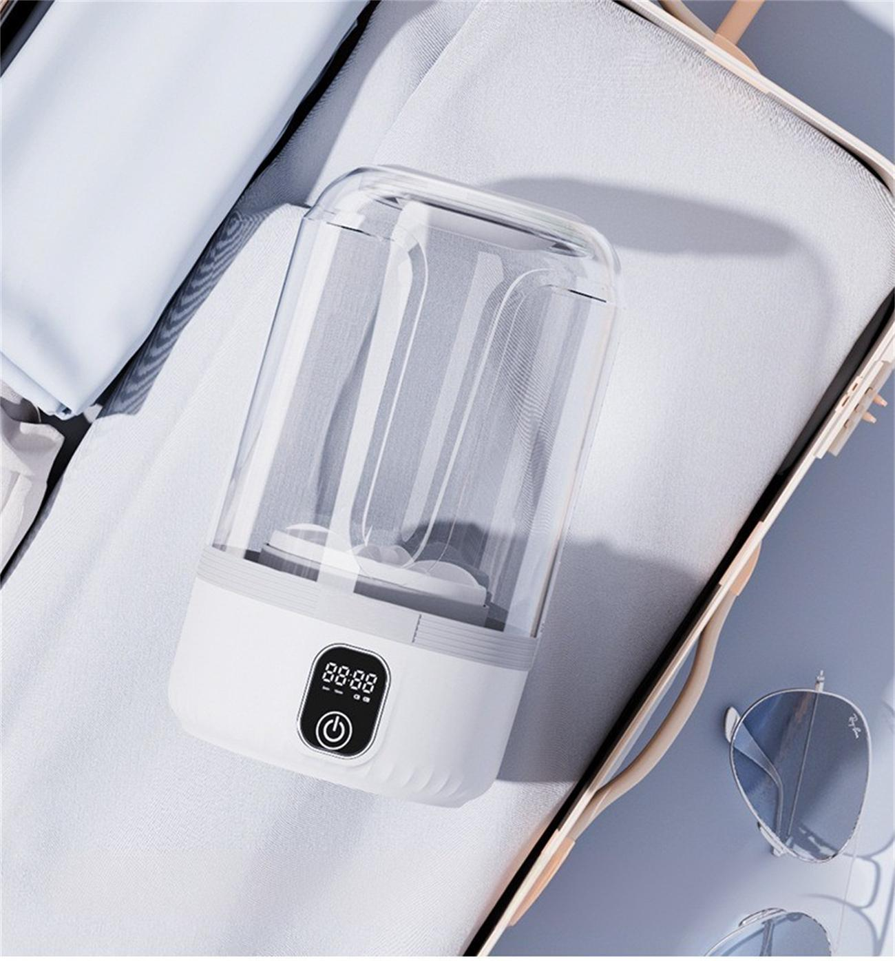 Ein weißes zylindrisches Gerät mit Digitalanzeige, möglicherweise ein Sterilisator, in einem Koffer.