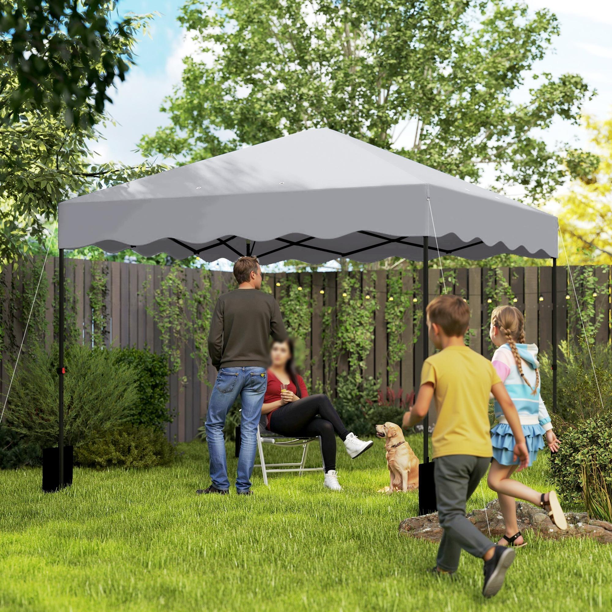 Familie unter einem grauen Pavillon im Garten, mit einem Hund.