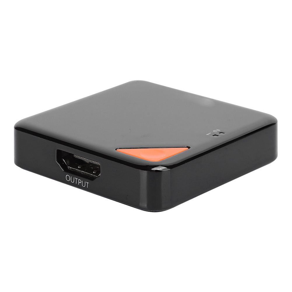Ein schwarzes, quadratisches Gerät mit einem orangefarbenen Dreieck und einem HDMI-Anschluss mit der Aufschrift 'OUTPUT'.