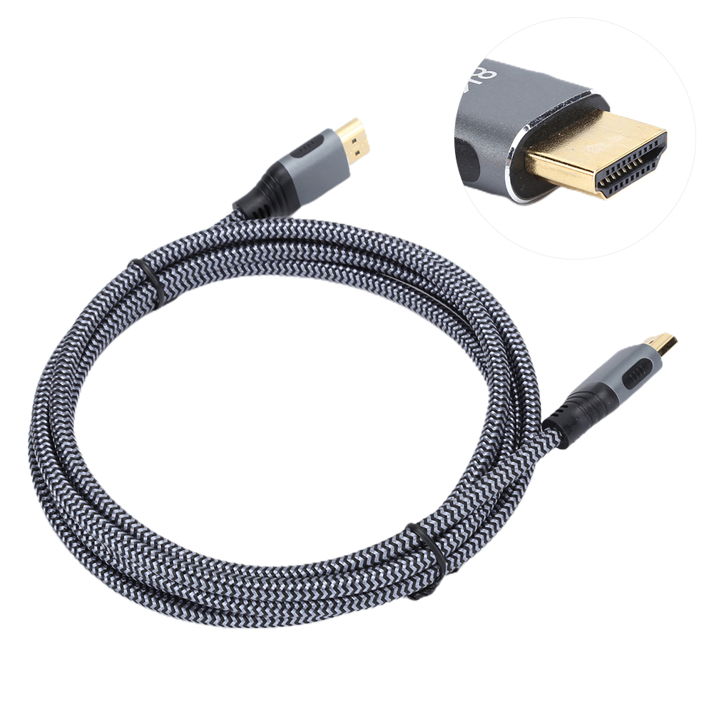 Ein aufgerolltes HDMI-Kabel mit grauem Gehäuse und Goldstecker auf weißem Hintergrund.