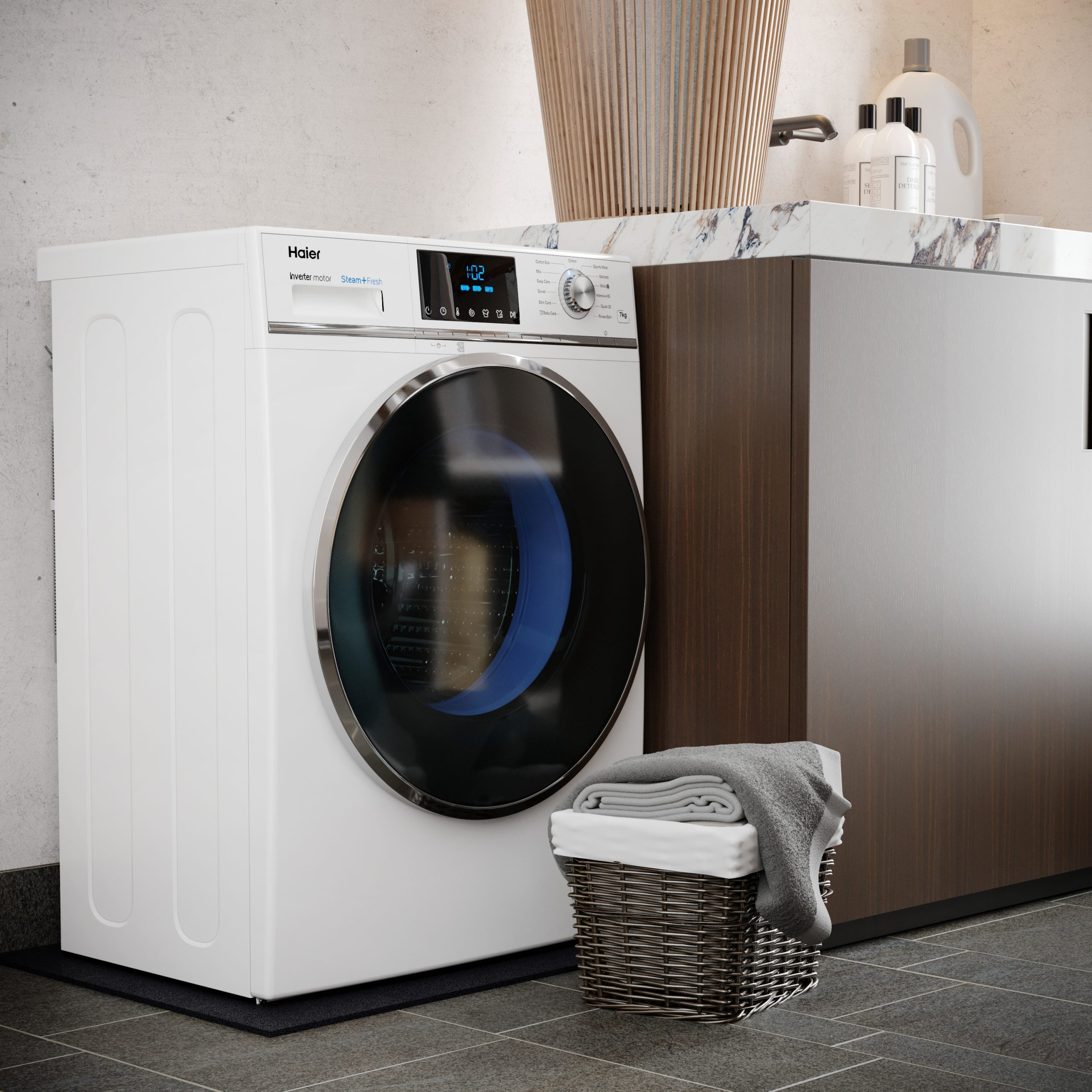 A white washing machine with a black mat in front of it. Behind the machine is a wicker basket.
