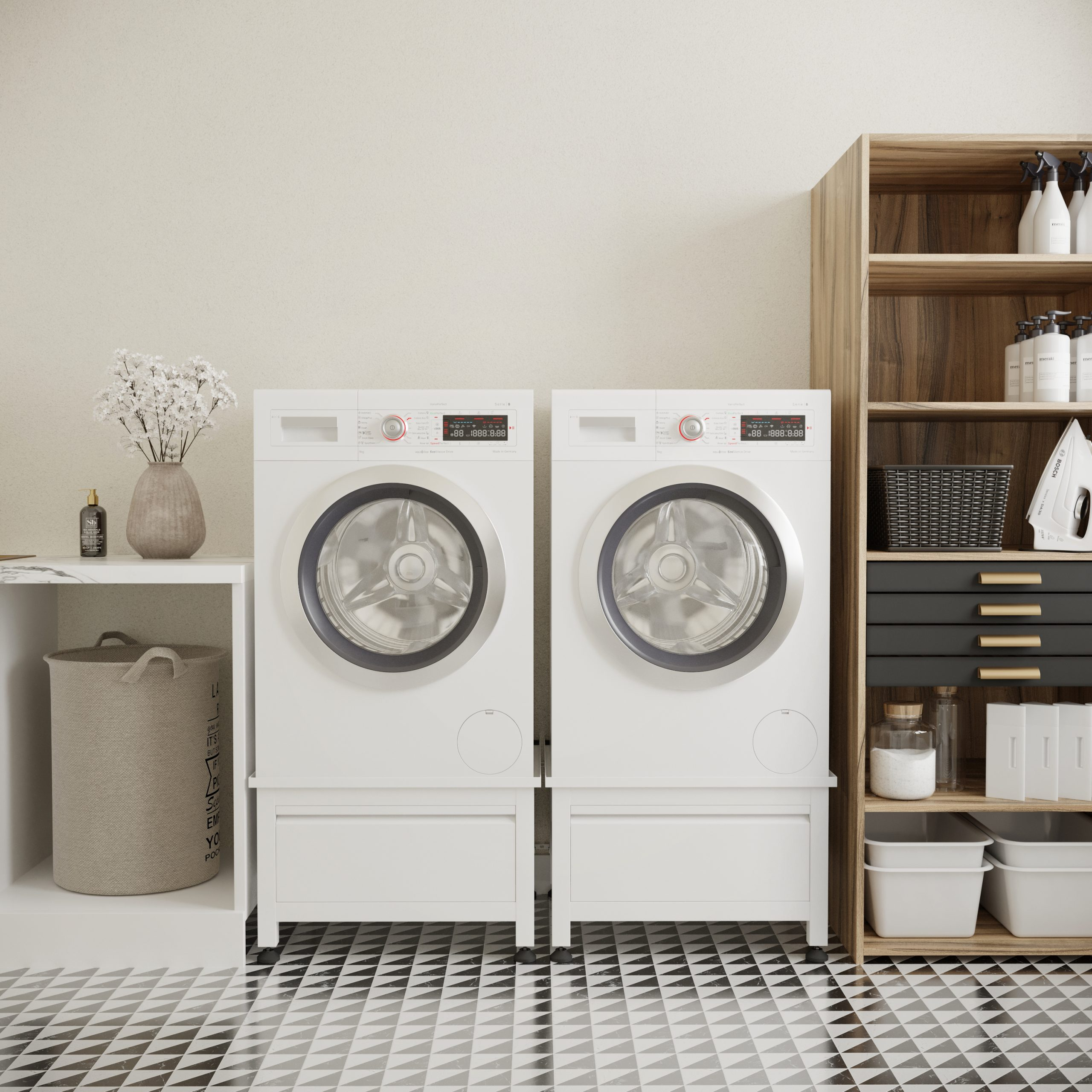 Two white washing machines in a laundry room. Beige walls, black and white patterned floor. Wooden shelf on right.