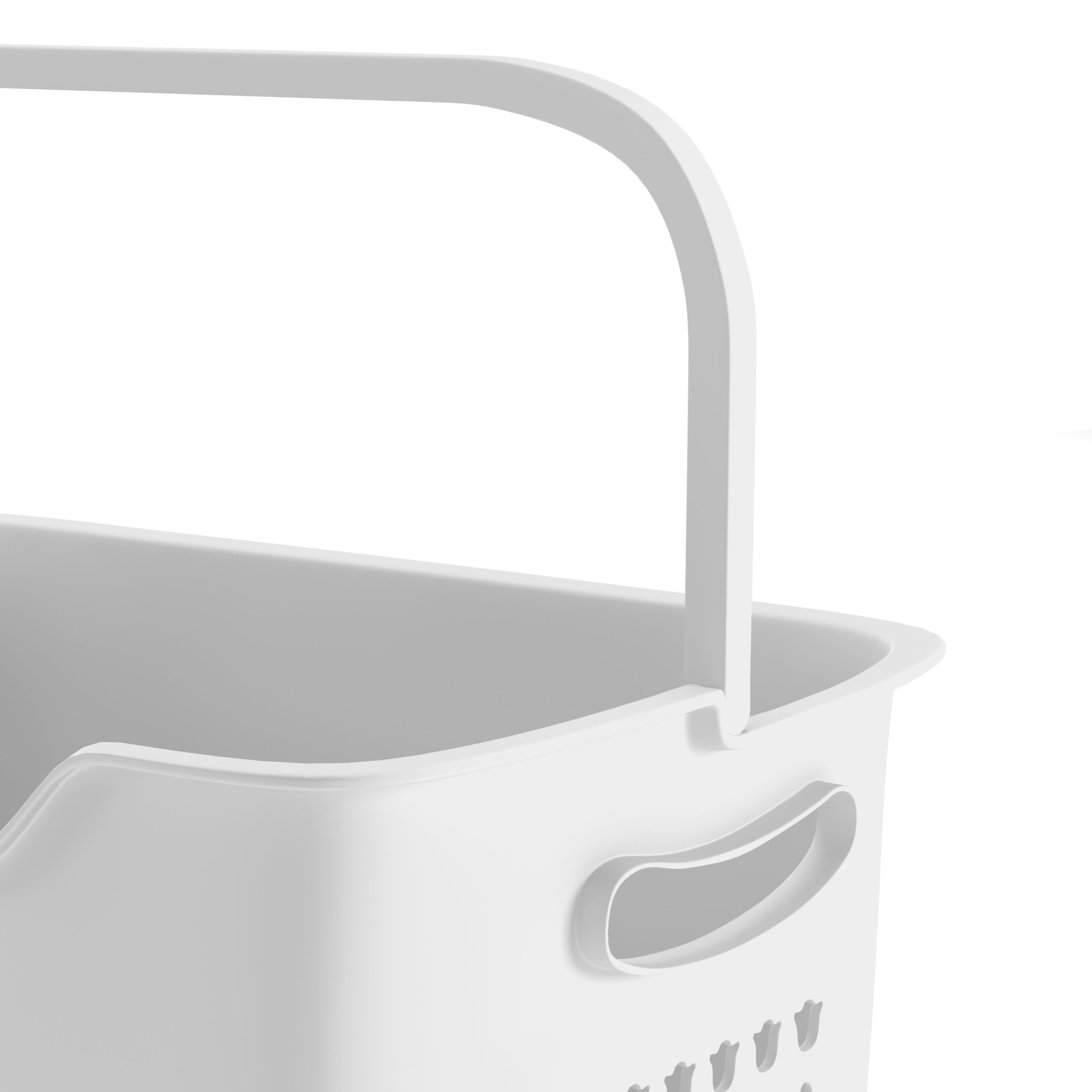 Gros plan sur la poignée d'un panier à linge blanc. Le panier a une poignée légèrement incurvée et des trous.