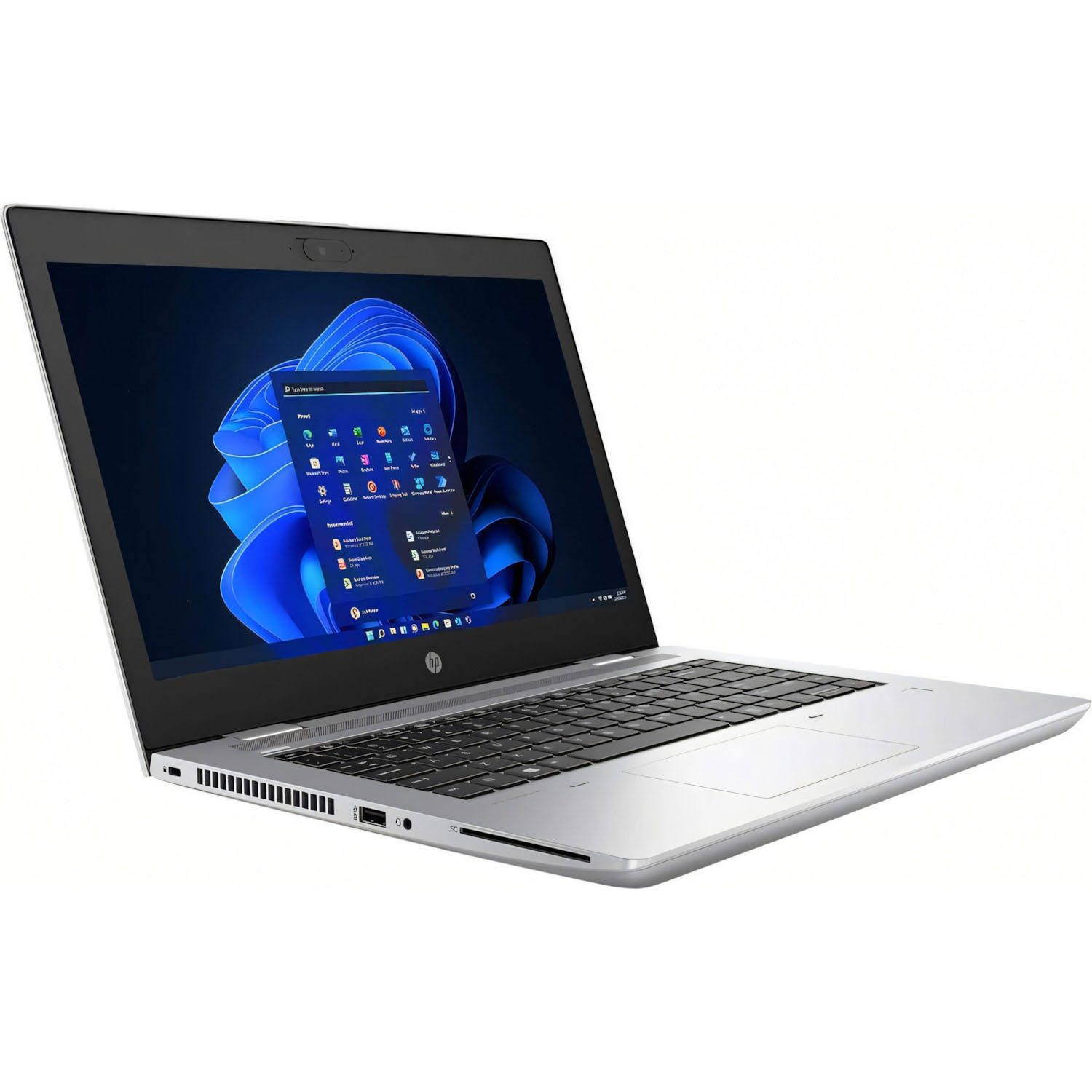 Portátil plateado abierto, pantalla de Windows 11 visible. Teclado y panel táctil negros.