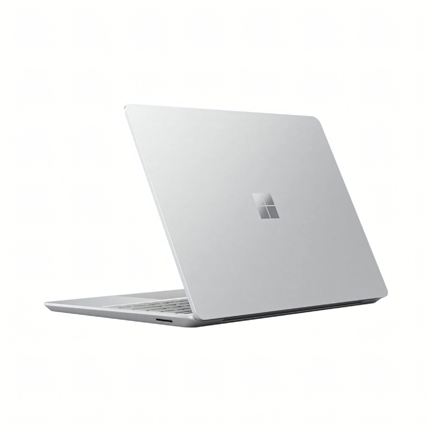 Laptop Microsoft plateado, cerrado, vista trasera mostrando el logo.