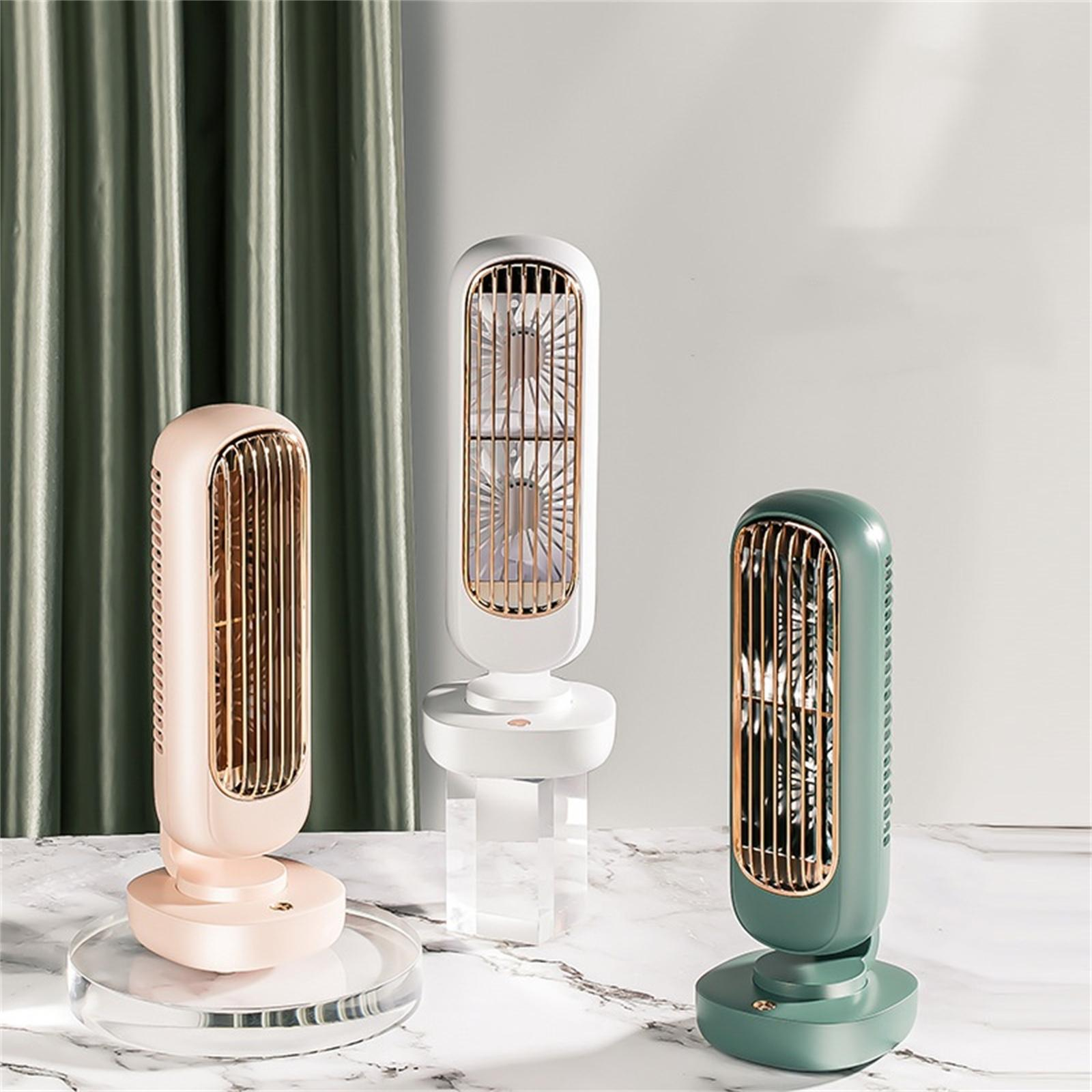 Drei Ventilatoren in verschiedenen Farben. Pink, weiß und grün, jeweils auf einem Ständer.