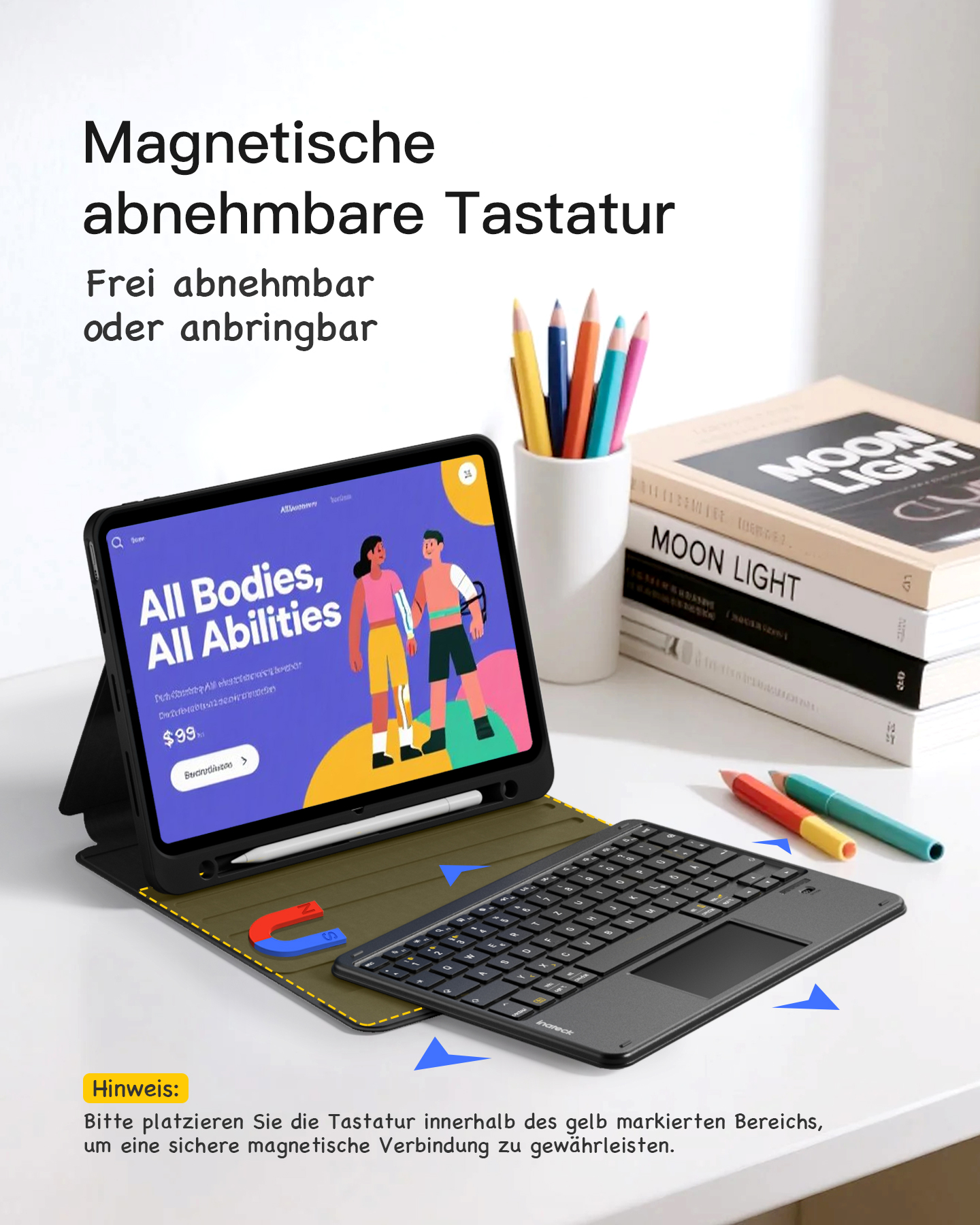 Ein iPad mit angeschlossener Tastatur, mit Stiften und Büchern in der Nähe. Die Tastatur ist magnetisch befestigt.