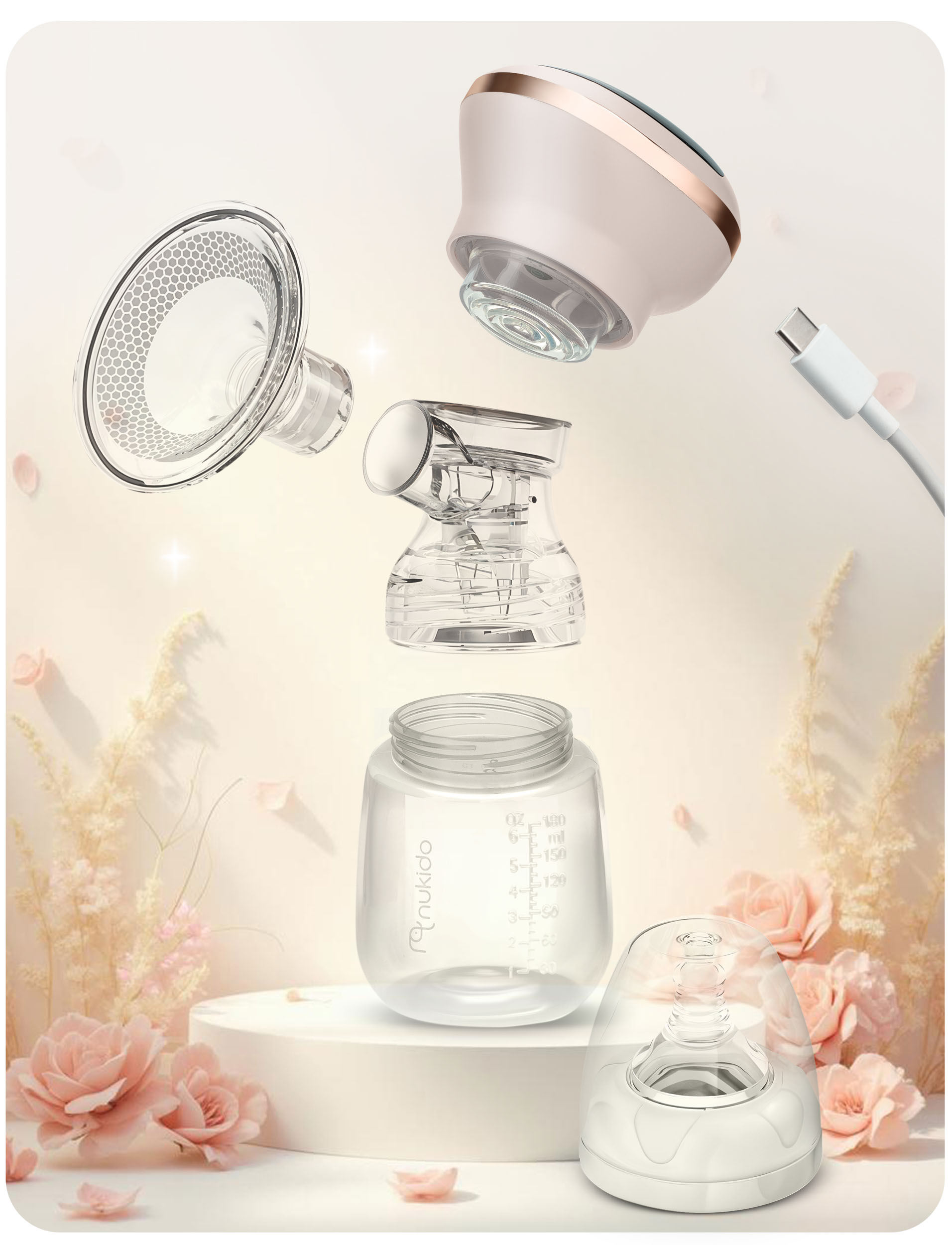 Laktator zdemontowany. Różne części są pokazane. Przezroczysty plastik i inne części. Różowe kwiaty.