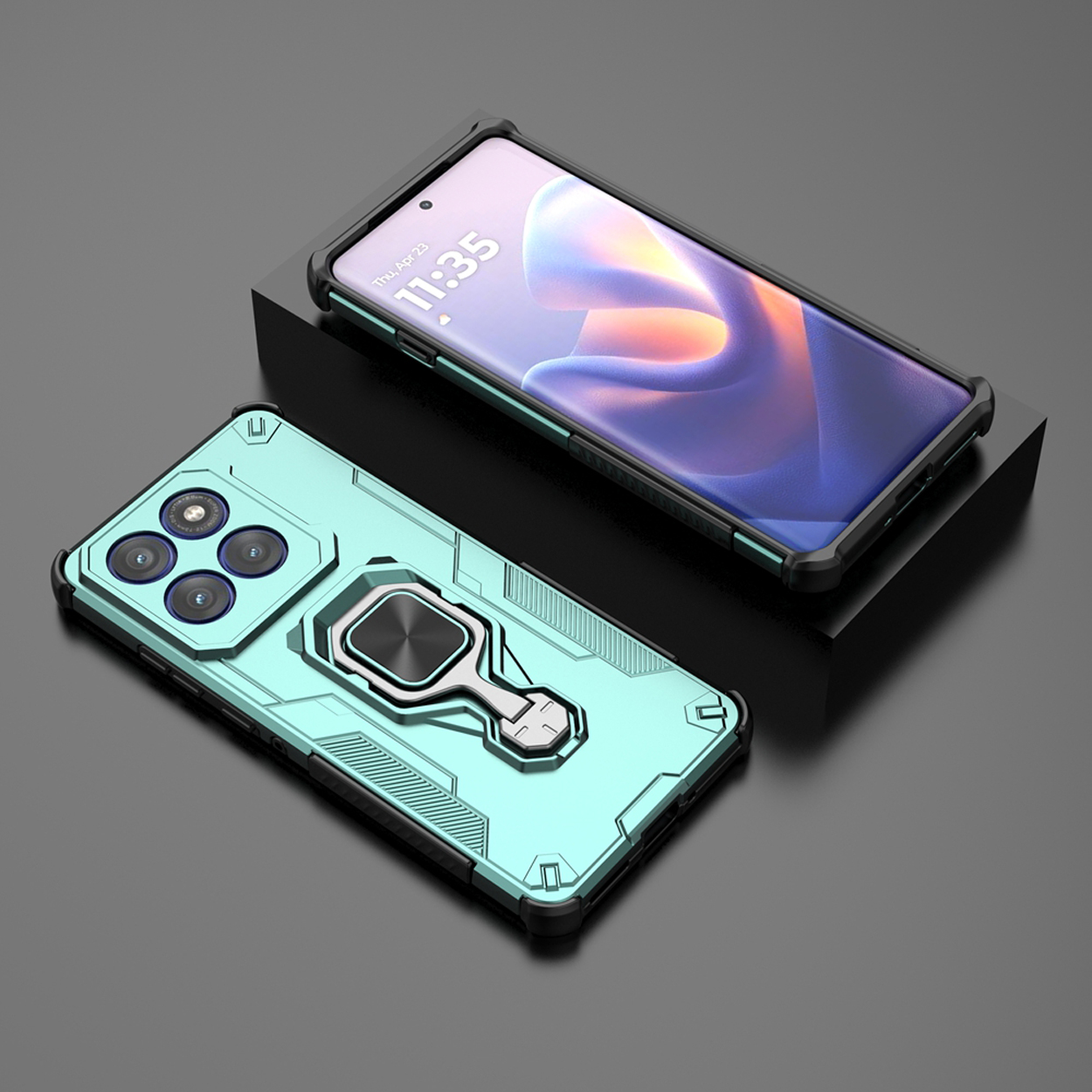 Een turquoise telefoonhoes met een ringhouder ligt op een zwart oppervlak. Een andere telefoon staat op de achtergrond.
