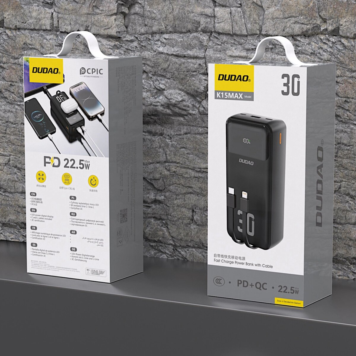 Dwa pudełka power bank. Każde pudełko pokazuje power bank z marką DUDAO i informacjami o produkcie.