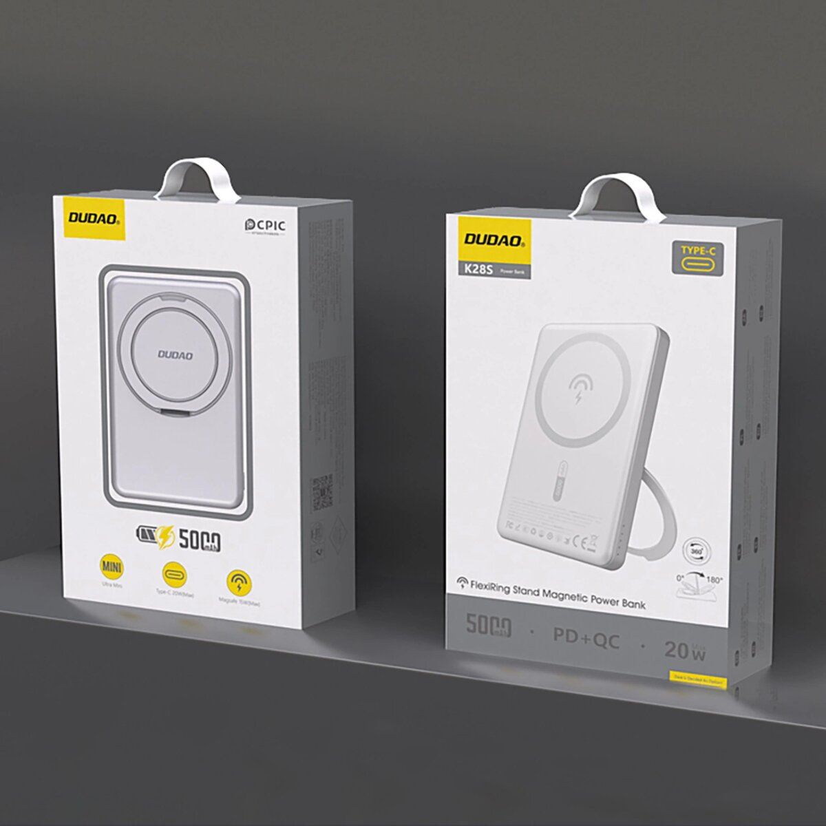 Dwa białe pudełka z power bankami. Lewe mówi "Mini", prawe "K28S". Oba mają logo.