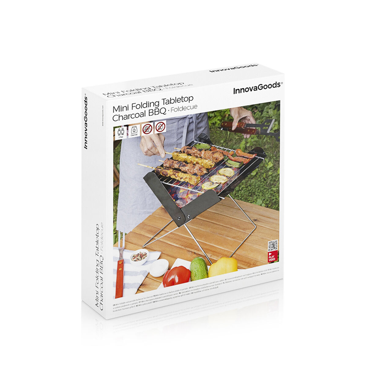 Caja para mini barbacoa de carbón plegable de mesa con comida a la parrilla. Marca InnovaGoods mostrada.