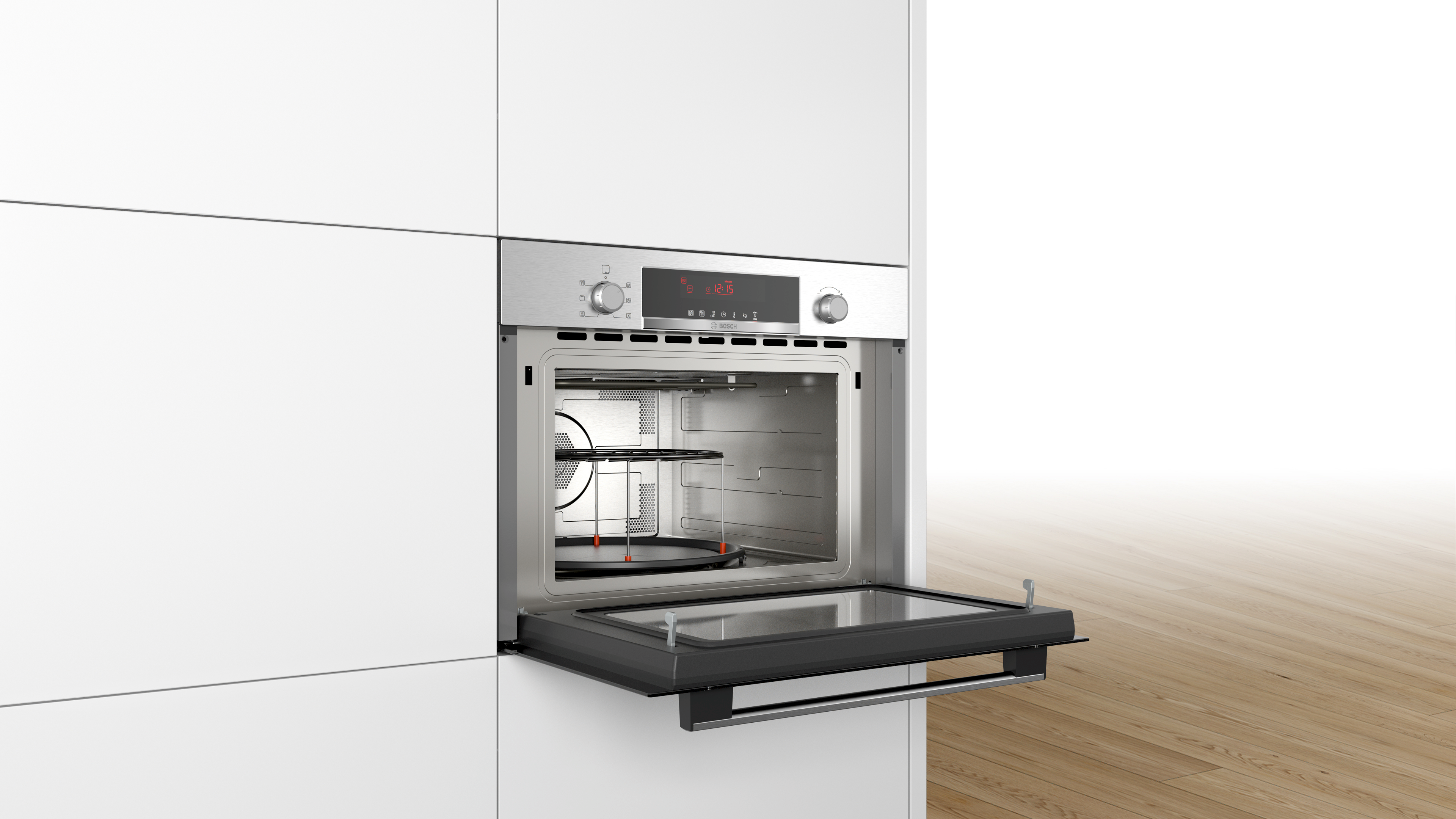 Built-in microwave oven open. Stainless steel interior, glass door, and a rack inside. Set in white cabinets.
