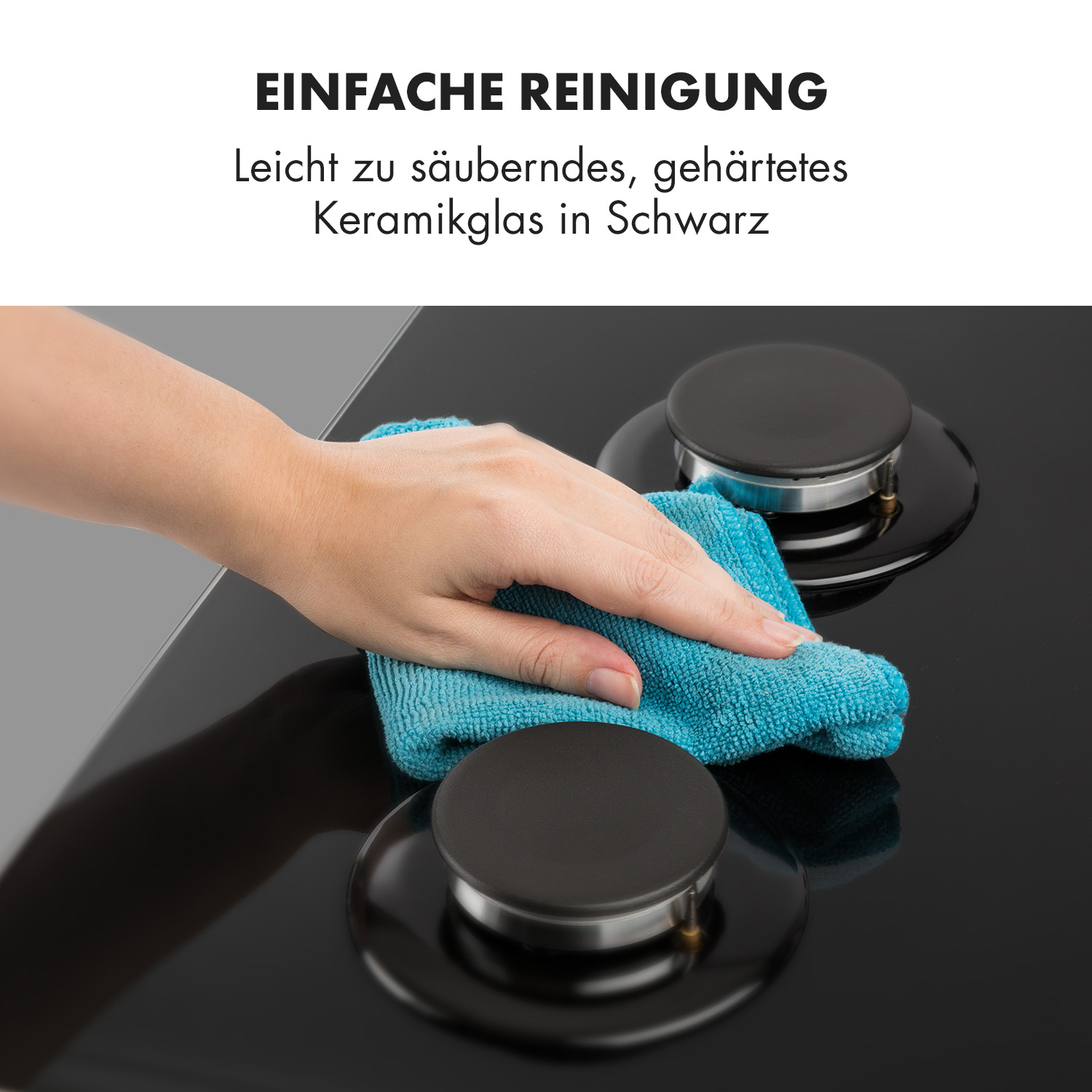 Hand reinigt einen schwarzen Gasherd mit einem blauen Tuch. Die Oberfläche ist glänzendes Keramikglas.