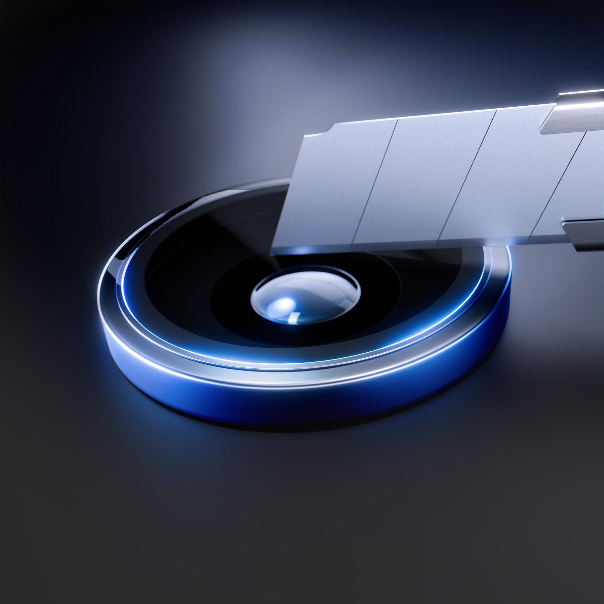 Ostrze noża do tapet umieszczone nad świecącym niebieskim okręgiem na ciemnym tle. Ostrze jest metaliczne i ostre.