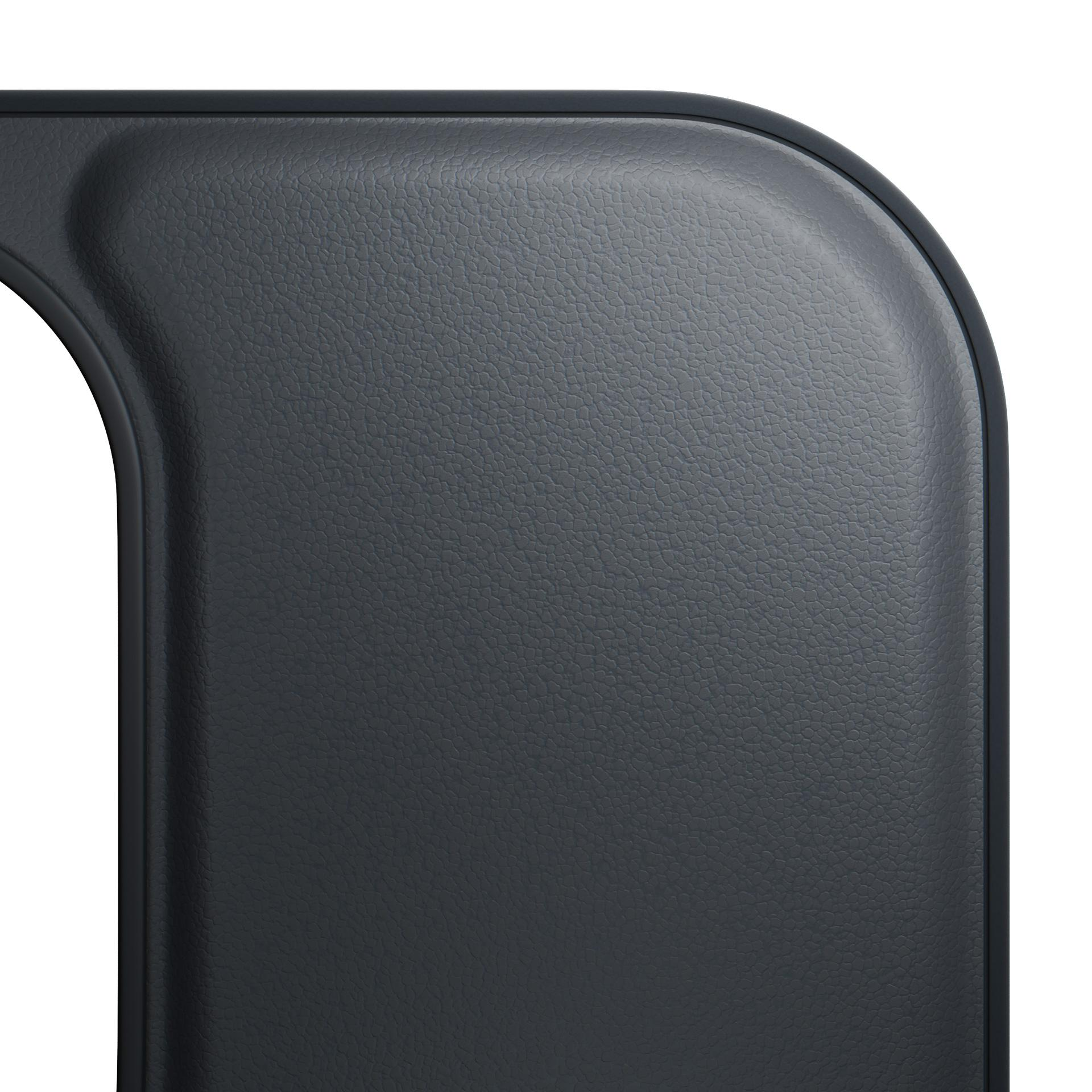 Un primo piano mostra una superficie curva, strutturata, grigio scuro con cornice nera e spazio bianco sullo sfondo.