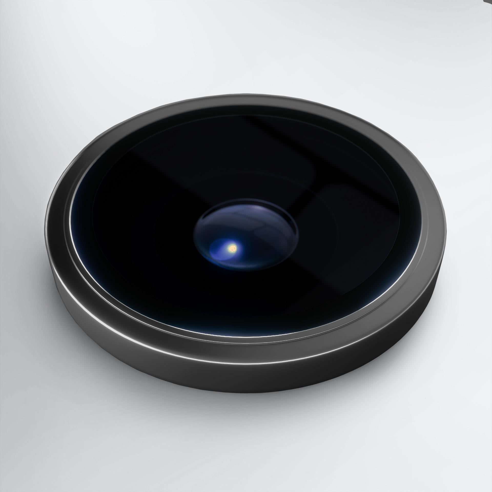 Zbliżenie obiektywu aparatu w telefonie. Czarna soczewka z jasnym odbiciem pośrodku, na białym tle.