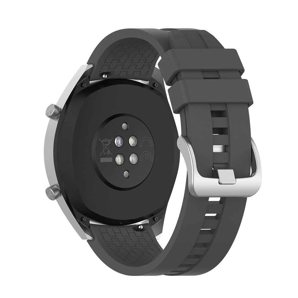 Graue Smartwatch, Rückansicht, zeigt Armband und Zifferblatt. Die Uhr hat einen schwarzen runden Sensor und eine silberne Schnalle.