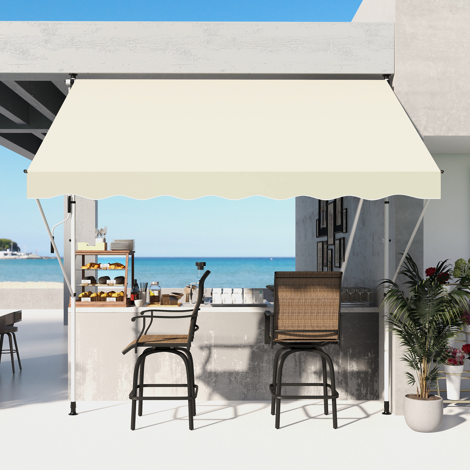 Ein Außenbereich mit Markise. Es gibt zwei Barhocker, eine Bar und einen Blick auf das Meer.