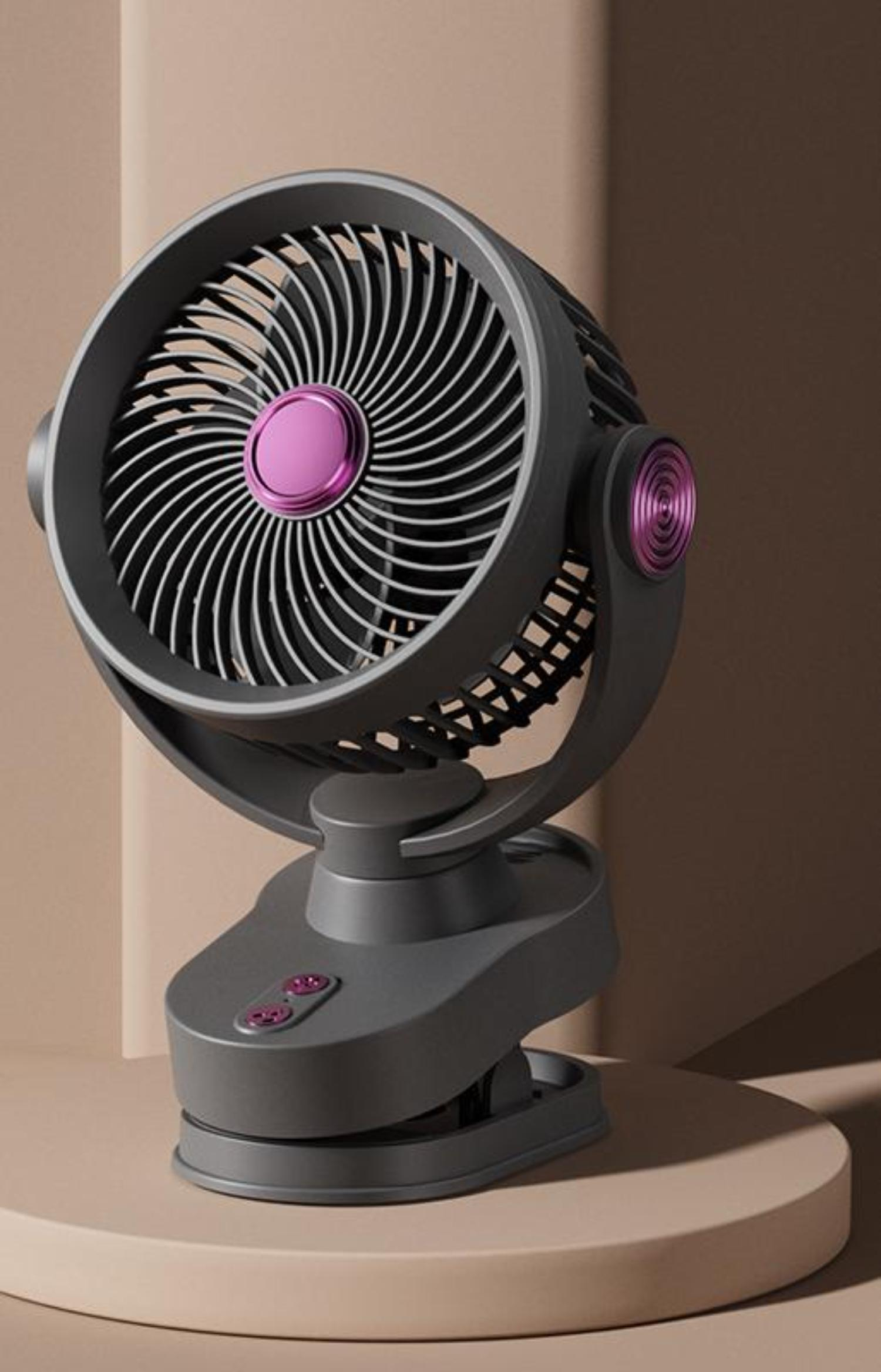 Ein grauer Schreibtischventilator mit rosa Mitte und rundem Sockel auf neutralem Hintergrund.