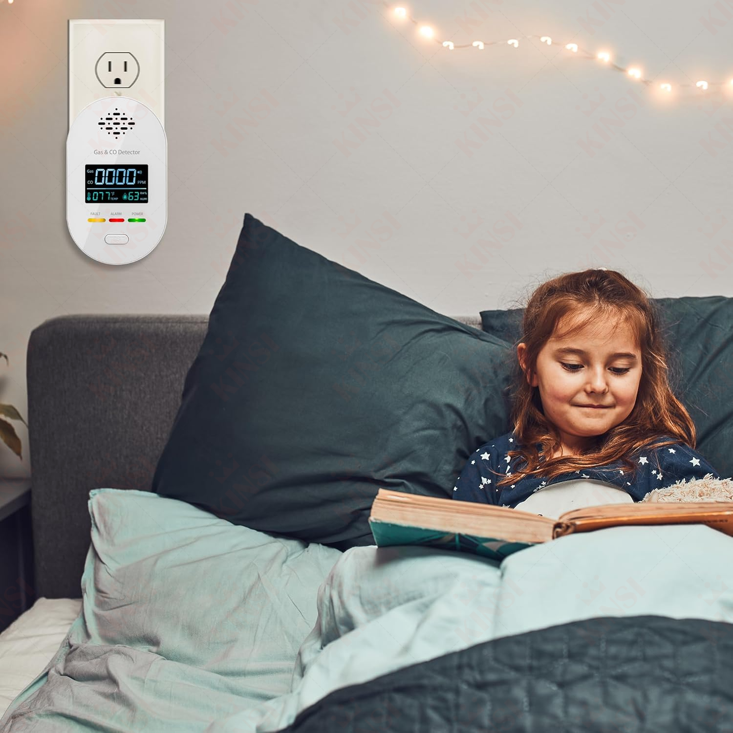 Ein Kind, das im Bett liest, neben einem in die Wand gesteckten Kohlenmonoxidmelder.