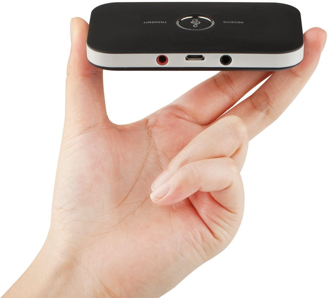 Eine Hand hält einen schwarzen Bluetooth-Sender und -Empfänger. Es hat Anschlüsse und einen Knopf. Der Hintergrund ist weiß.