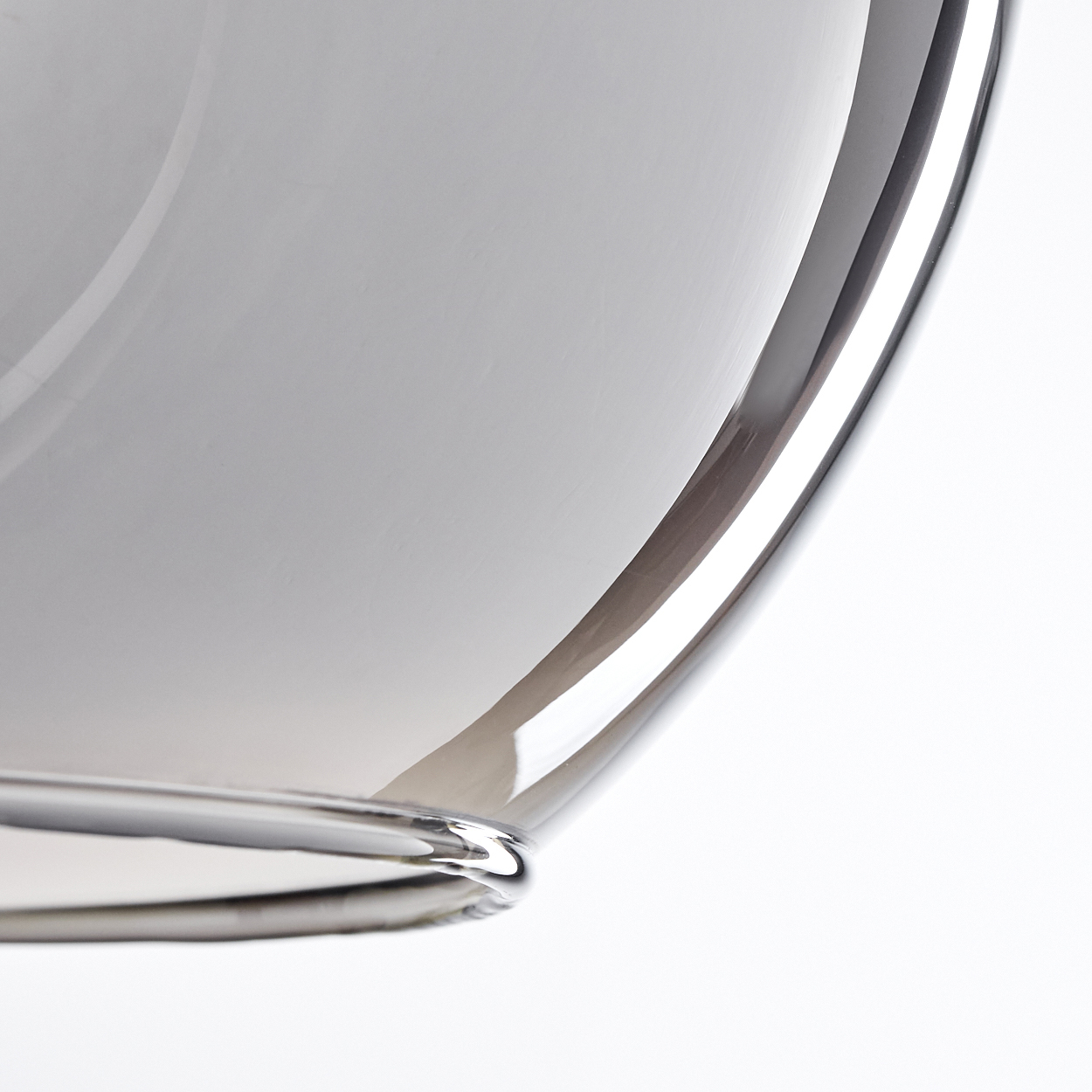 Nahaufnahme einer kugelförmigen Pendelleuchte mit Chromoberfläche, die Licht reflektiert.