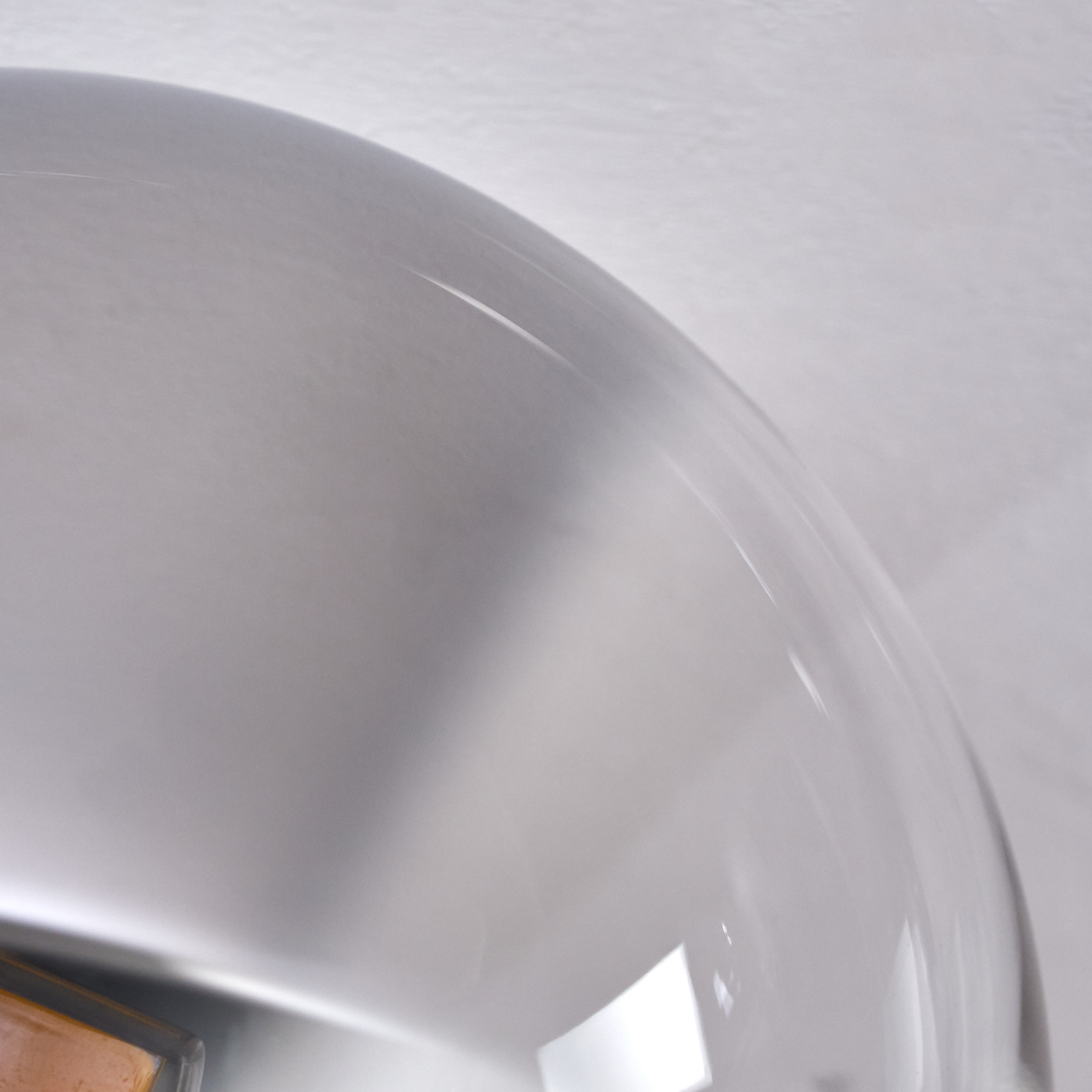 Nahaufnahme einer transparenten Glaslampe. Der Hintergrund ist weiß.