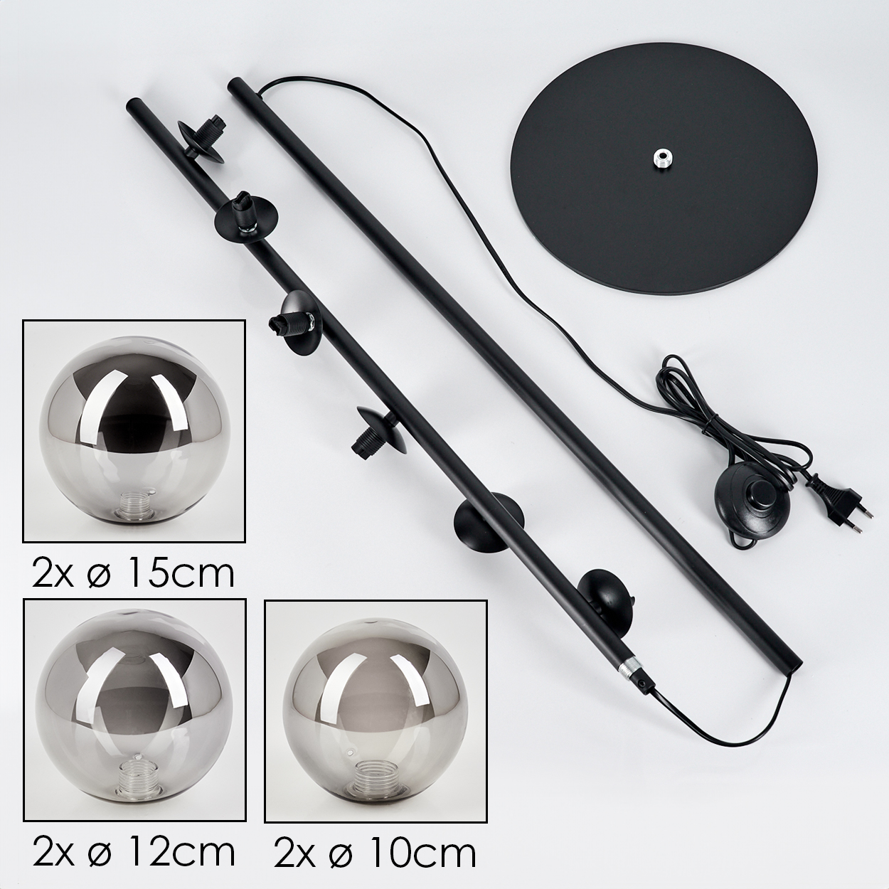 Zerlegte Stehlampe mit zwei Kugeln, schwarzen Stangenteilen, Basis und Dimmschalter.