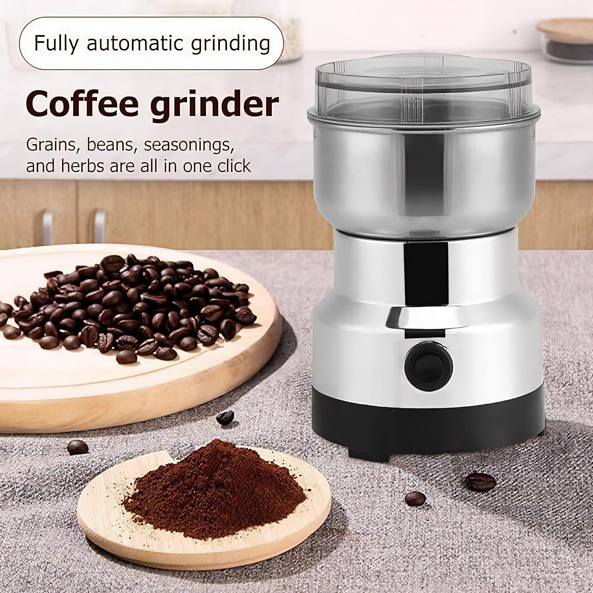 Eine Kaffeemühle mit Kaffeebohnen und gemahlenem Kaffee auf Holzoberflächen.