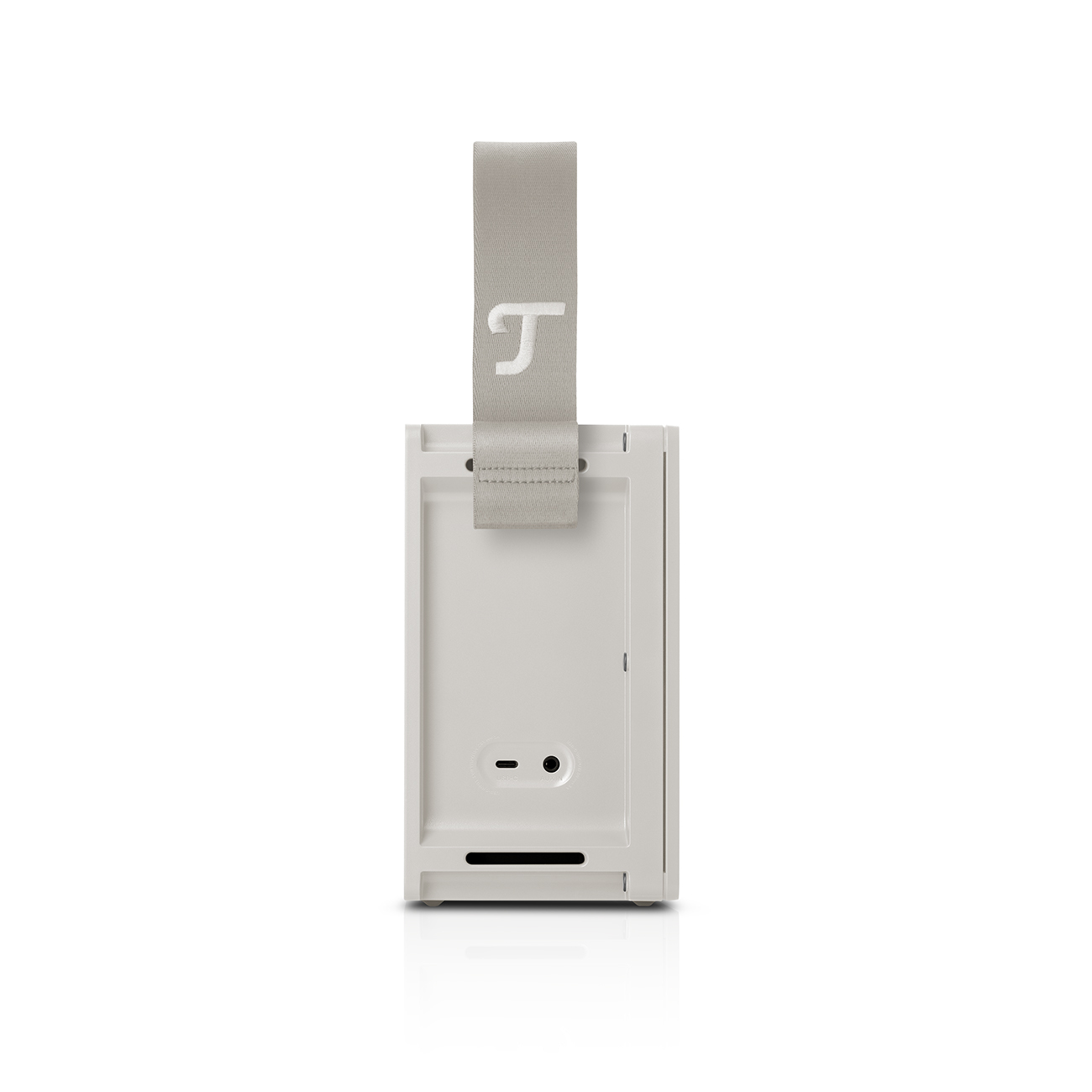 Haut-parleur portable rectangulaire blanc avec une sangle grise et la lettre 'T' dessus.