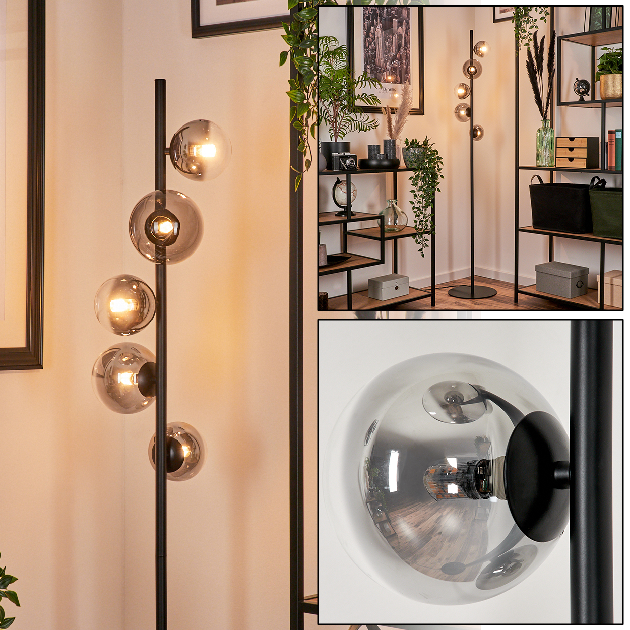 Eine hohe Lampe mit fünf kugelförmigen Glasschirmen mit Lichtern. Die Lampe ist schwarz, mit einer weißen Wand und einem gerahmten Bild.