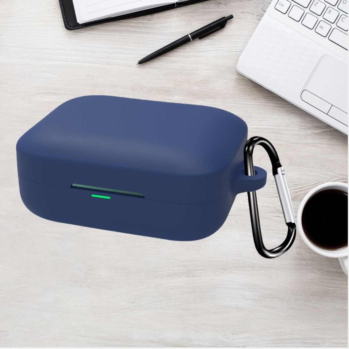 Custodia quadrata blu navy con moschettone, forse per auricolari, su superficie in legno.