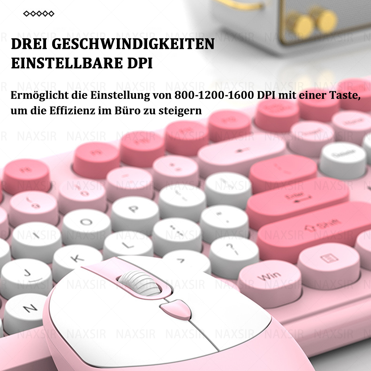 Eine rosa Tastatur und Maus auf einer rosa Oberfläche, Nahaufnahme.