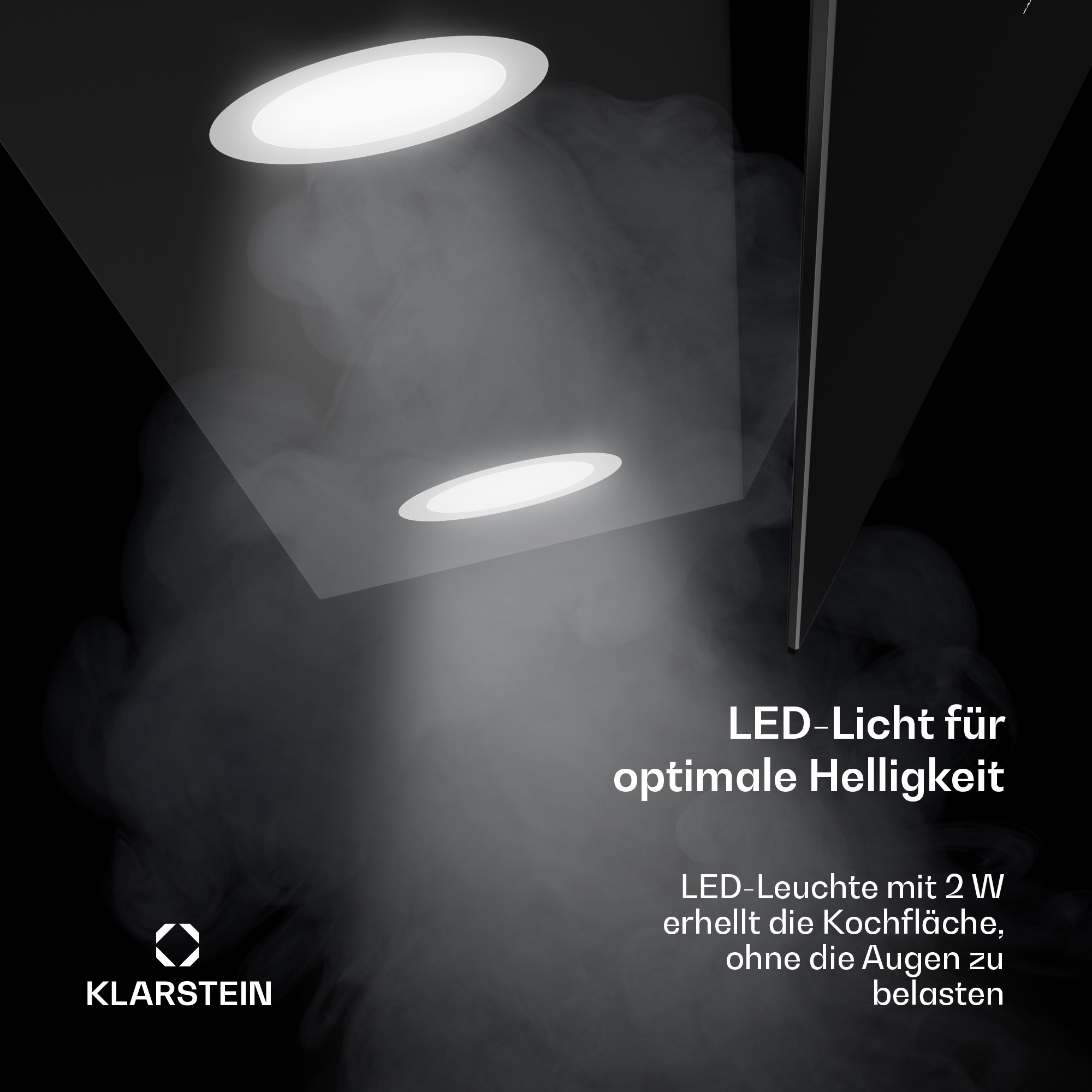 Una campana extractora negra con dos luces LED ilumina una zona de cocina llena de humo sobre un fondo oscuro.