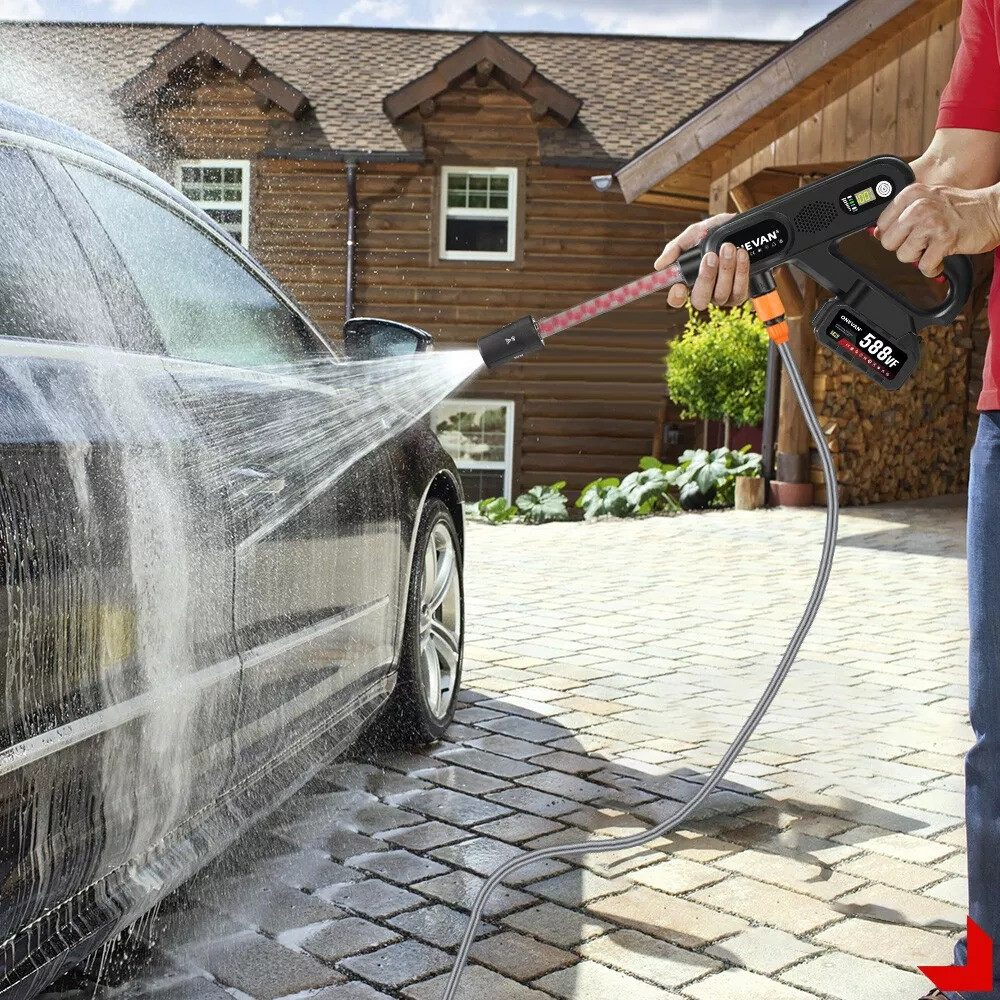 Ein Mann wäscht ein schwarzes Auto mit einem Hochdruckreiniger. Wasser spritzt auf das Auto.