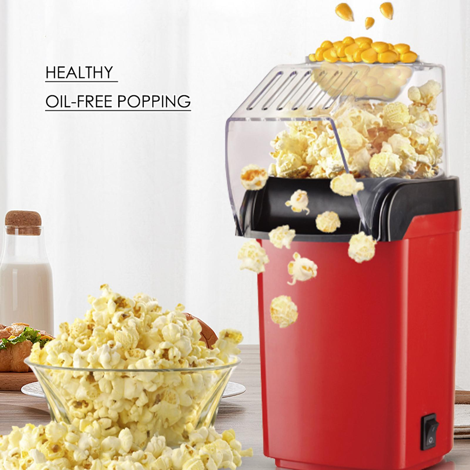 Rote Popcornmaschine mit Popcorn und Körnern. Text: "Gesundes ölfreies Poppen".