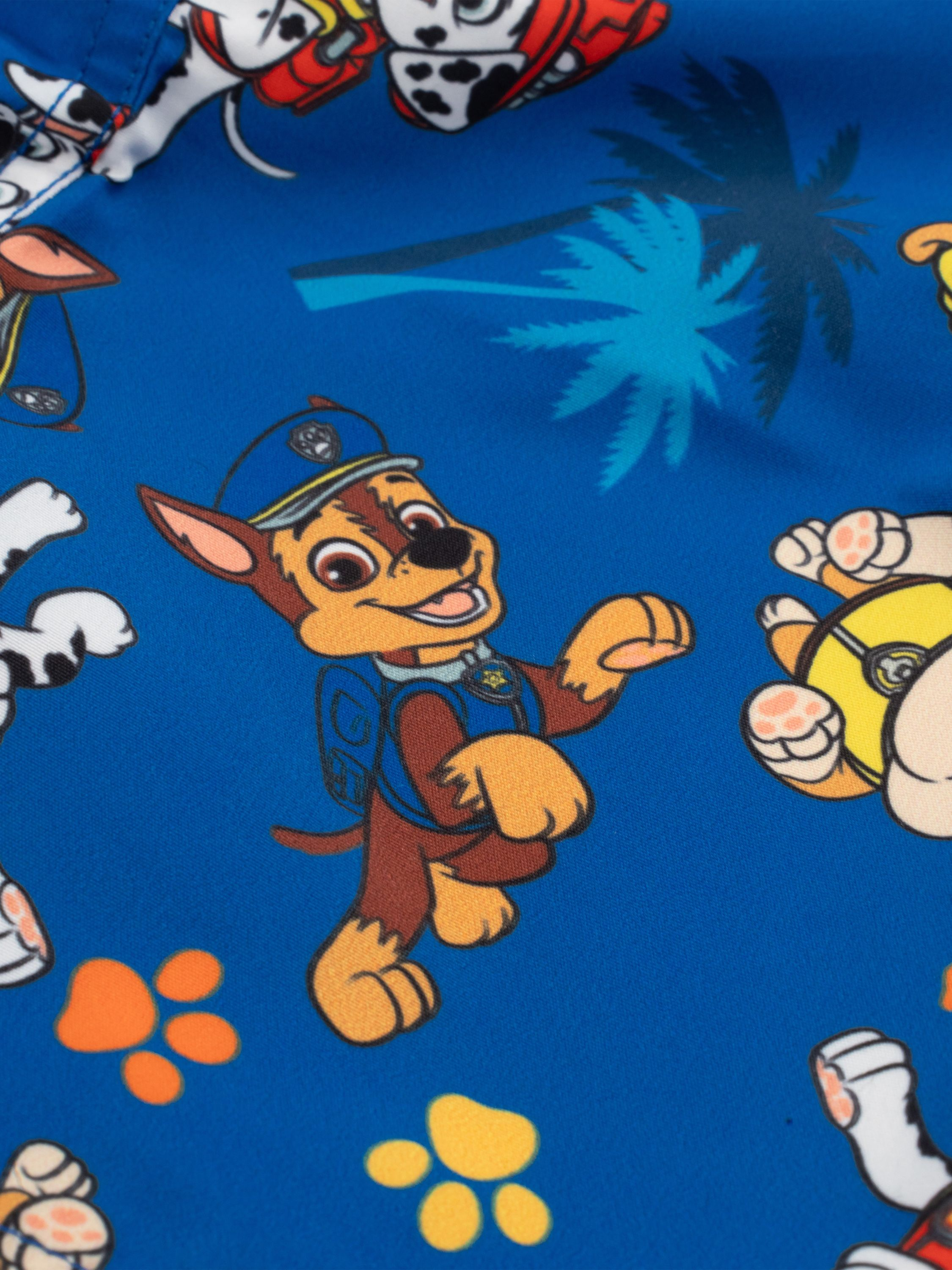Ein lebendiger, gemusterter blauer Stoff mit Zeichentrickfiguren von Paw Patrol. Der Hintergrund ist blau.