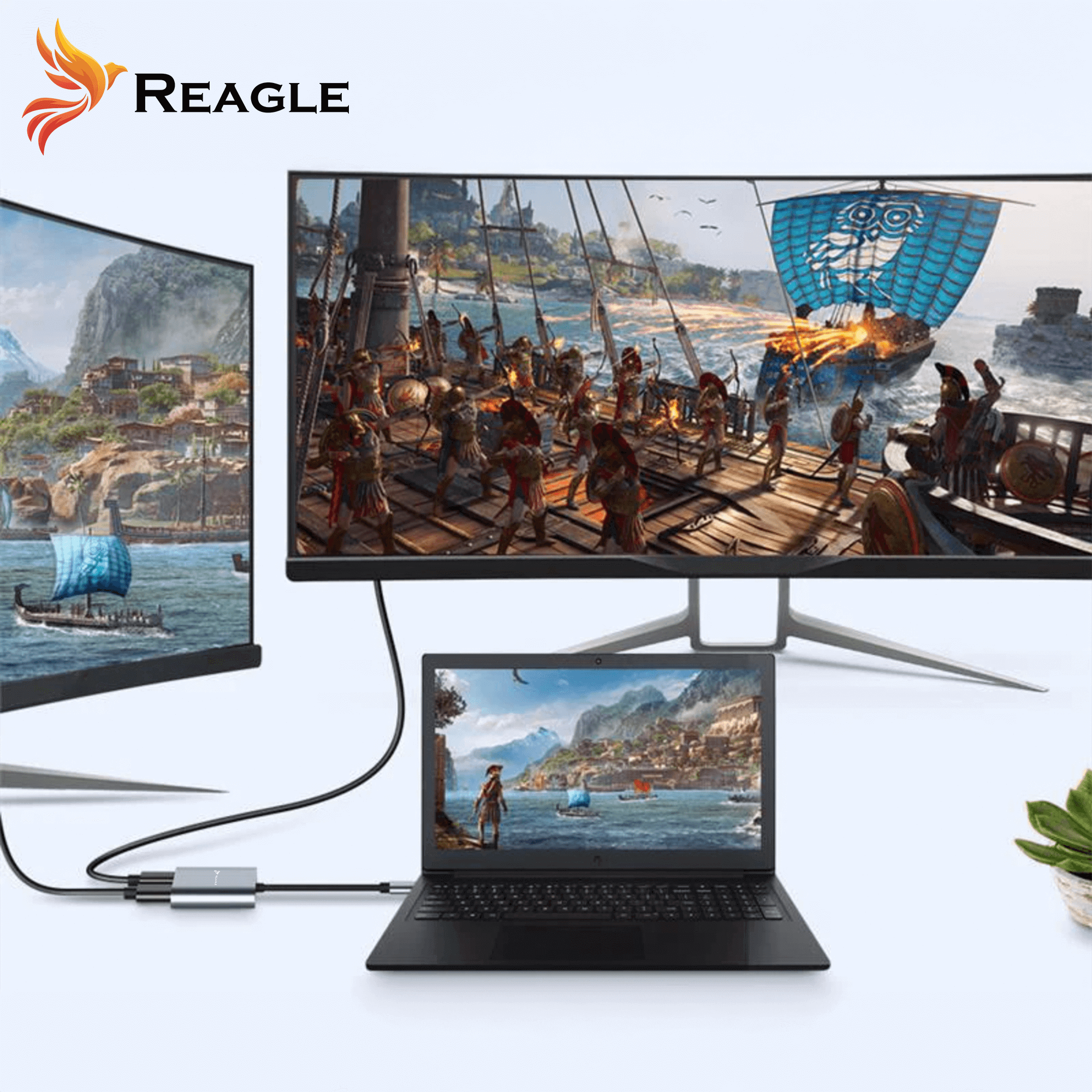 Laptop podłączony do monitora wyświetlającego scenę z gry. Adapter Reagle łączy je.