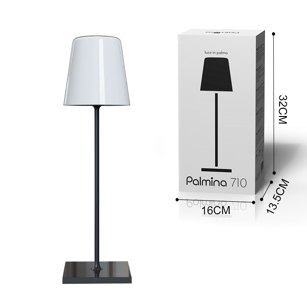 Una lampada con base nera e paralume bianco, accanto a una scatola con dimensioni.