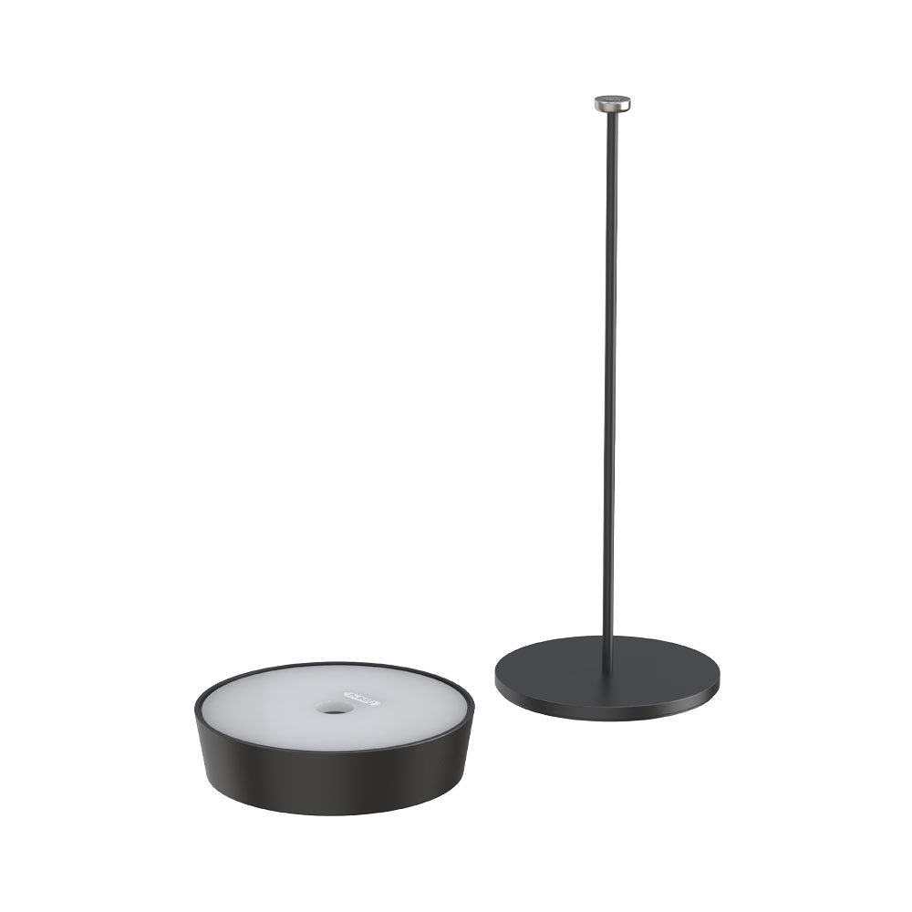 Una lampada nera smontata, con base, stelo e l'elemento luminoso separato.