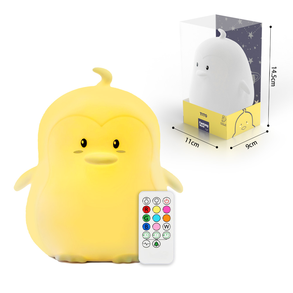 Una lampada a forma di pinguino giallo con telecomando e scatola.