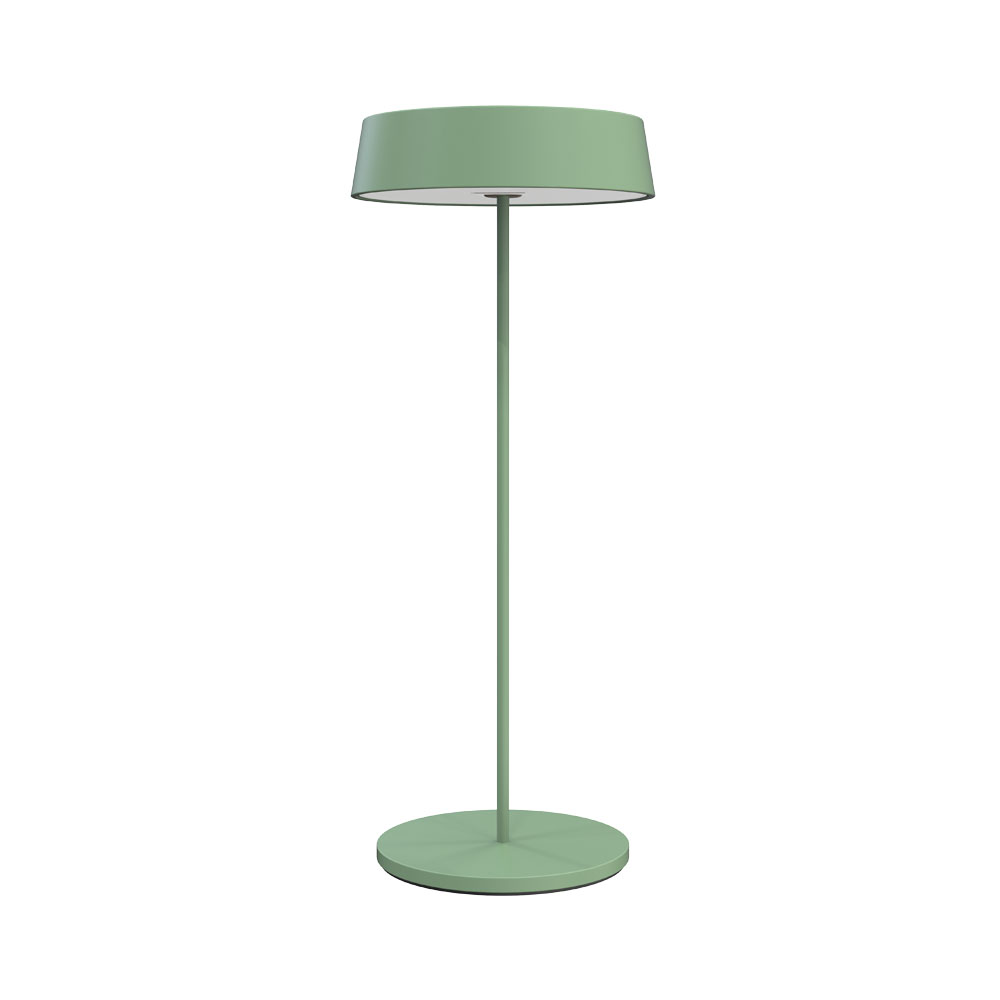 Una lampada verde con base rotonda e paralume.