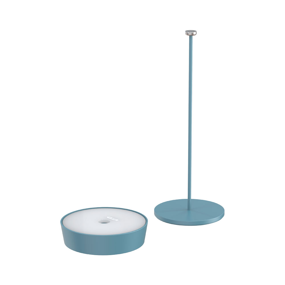 Una base per lampada color verde acqua con stelo abbinato e base rotonda, accanto a un contenitore rotondo.