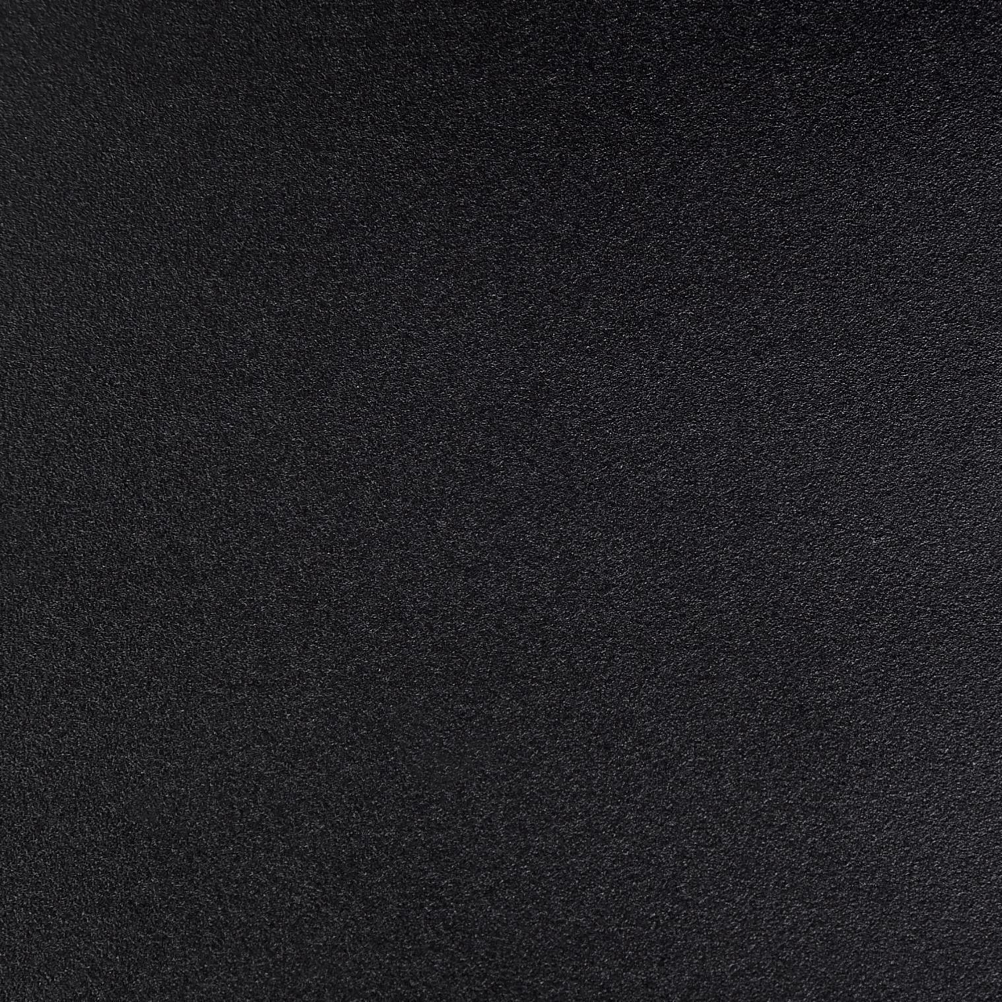 Nahaufnahme einer schwarzen, strukturierten Oberfläche. Die Oberfläche hat ein leicht raues, mattes Aussehen.
