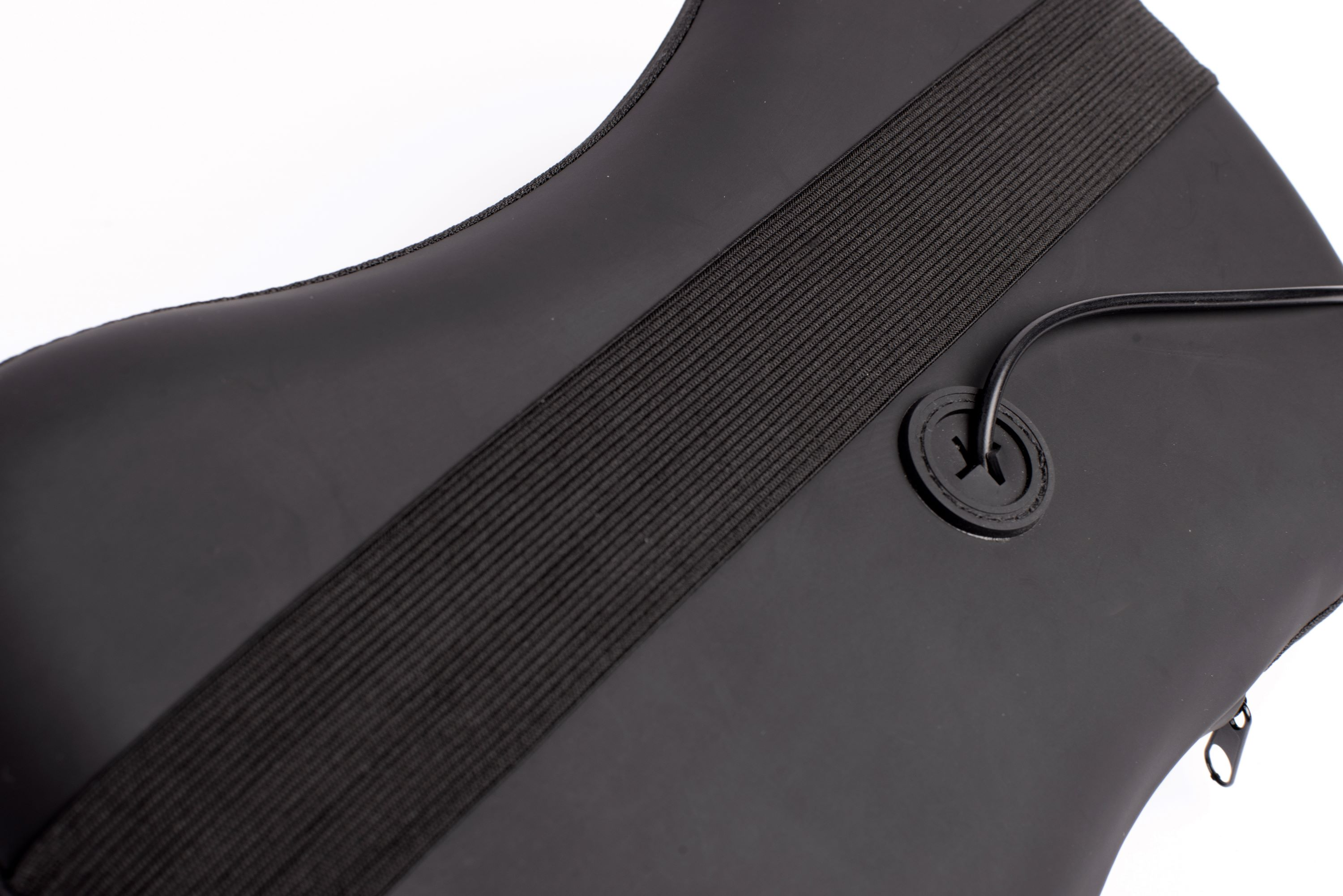 Close up of a black object with a black strap with a buckle and a small circular button.