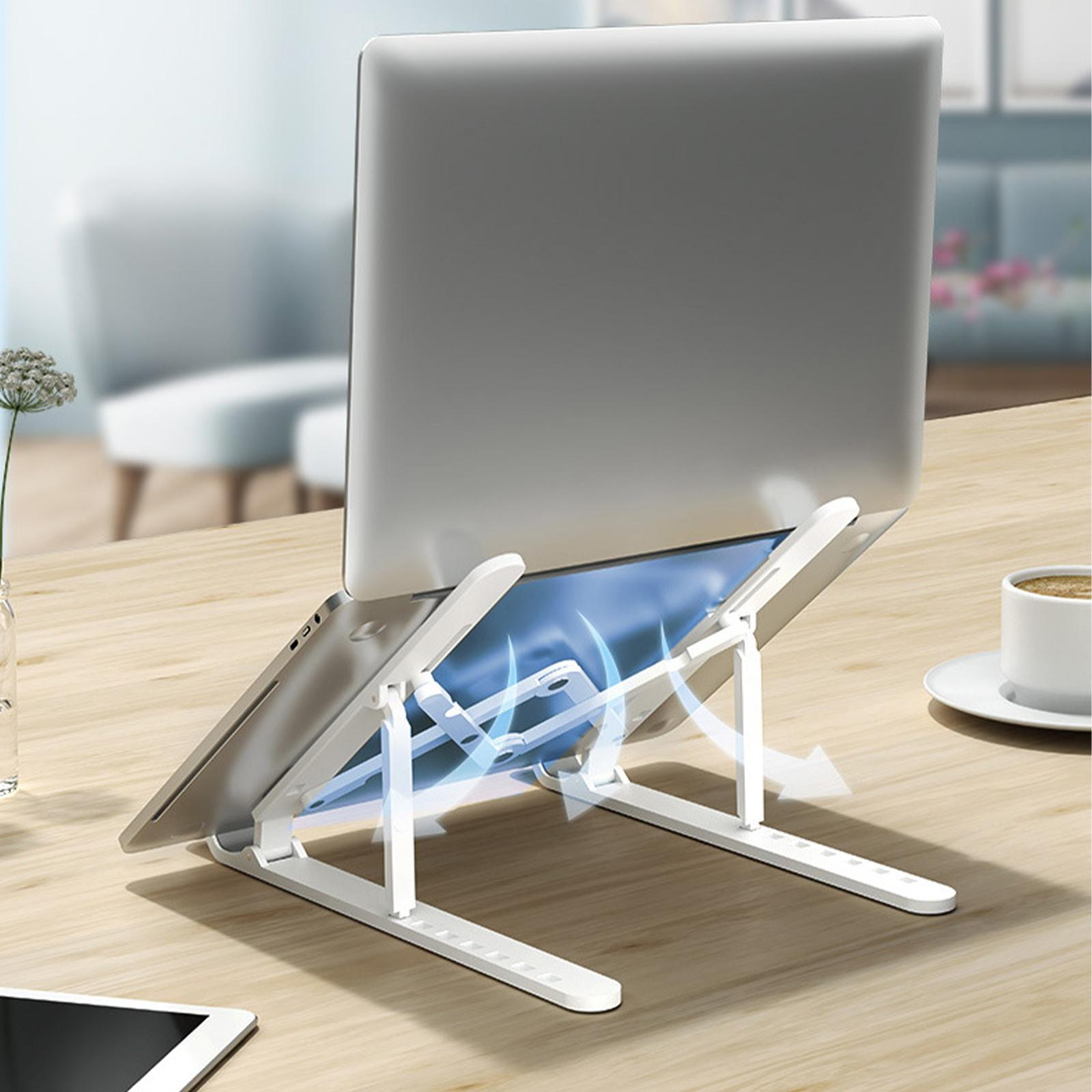 Ein weißer Laptop-Ständer mit einem Laptop und einer Tasse Kaffee.