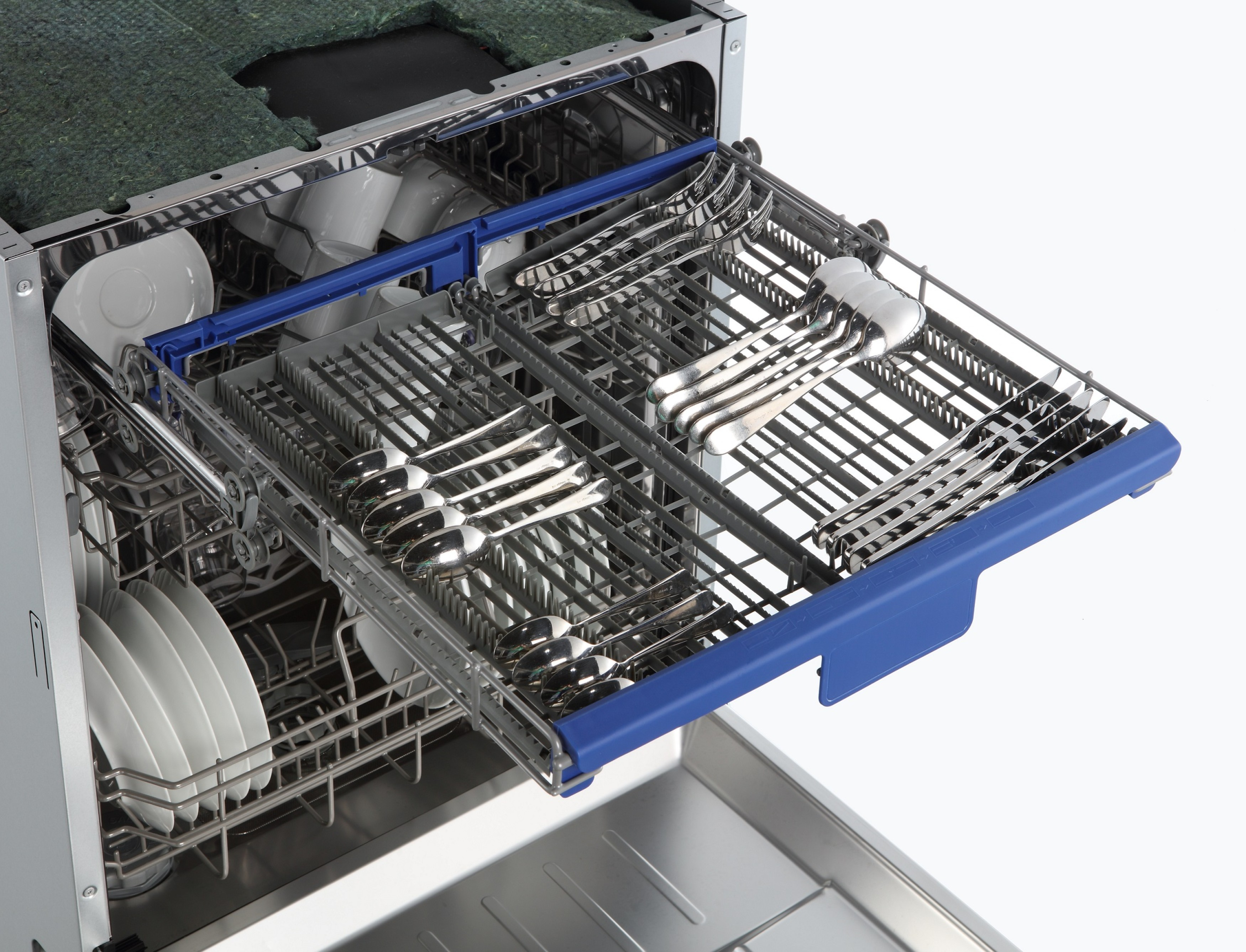 A dishwasher interior with silverware tray extended, full of forks, spoons, and knives.