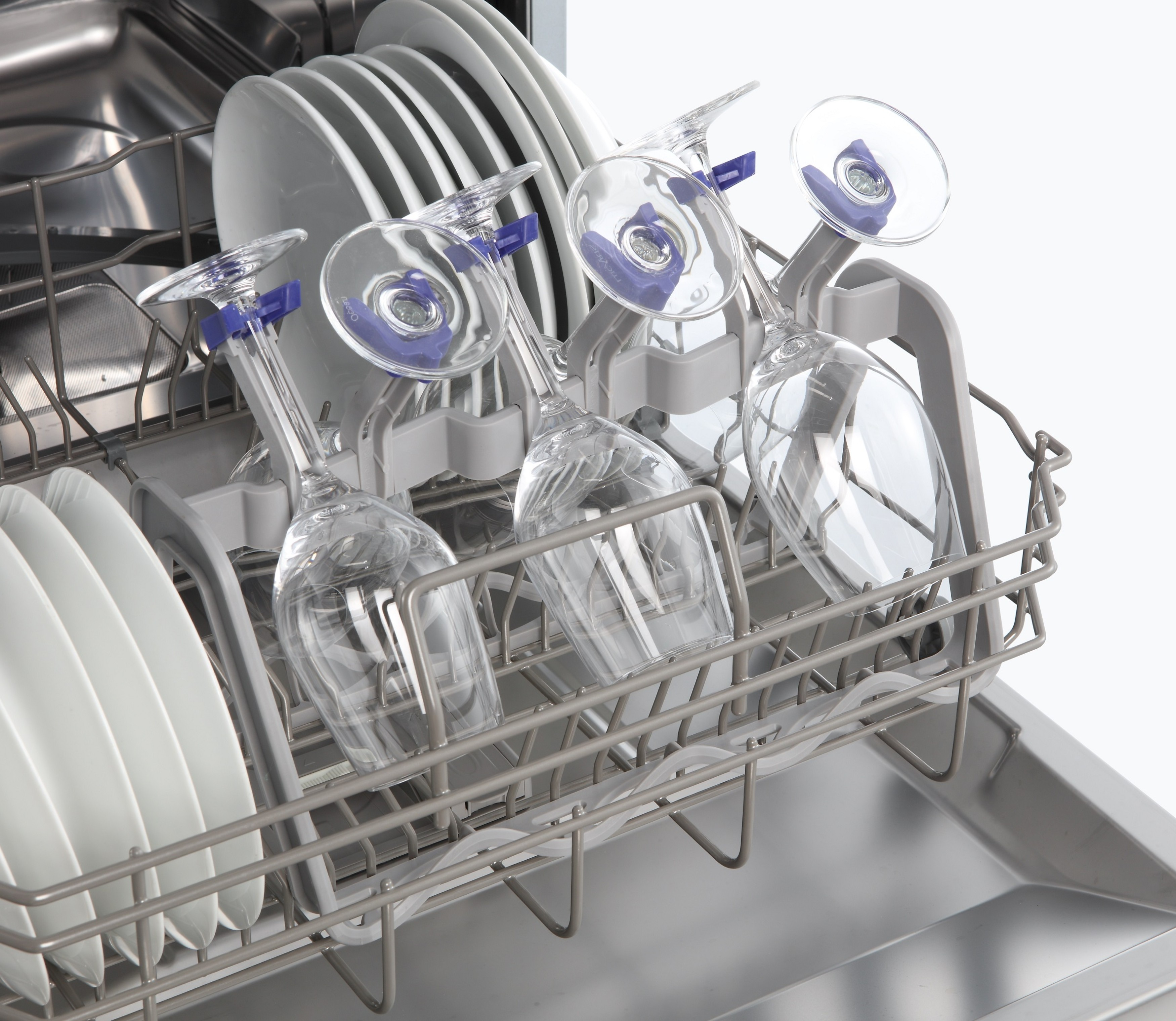 Glasses in a dishwasher rack, with a view of the interior and plates on the bottom.